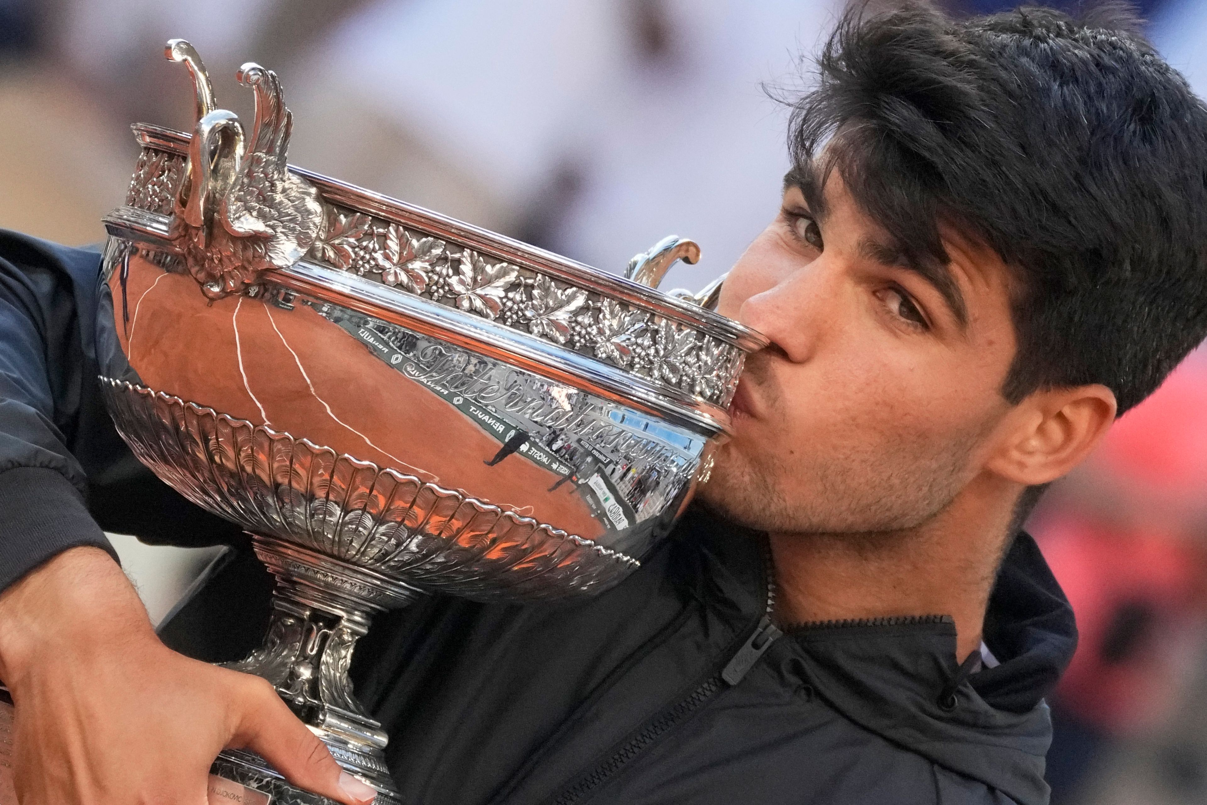 Spain's Carlos Alcaraz kisses the trophy after winning the men's final of the French Open tennis tournament against Germany's Alexander Zverev at the Roland Garros stadium in Paris, France, Sunday, June 9, 2024.