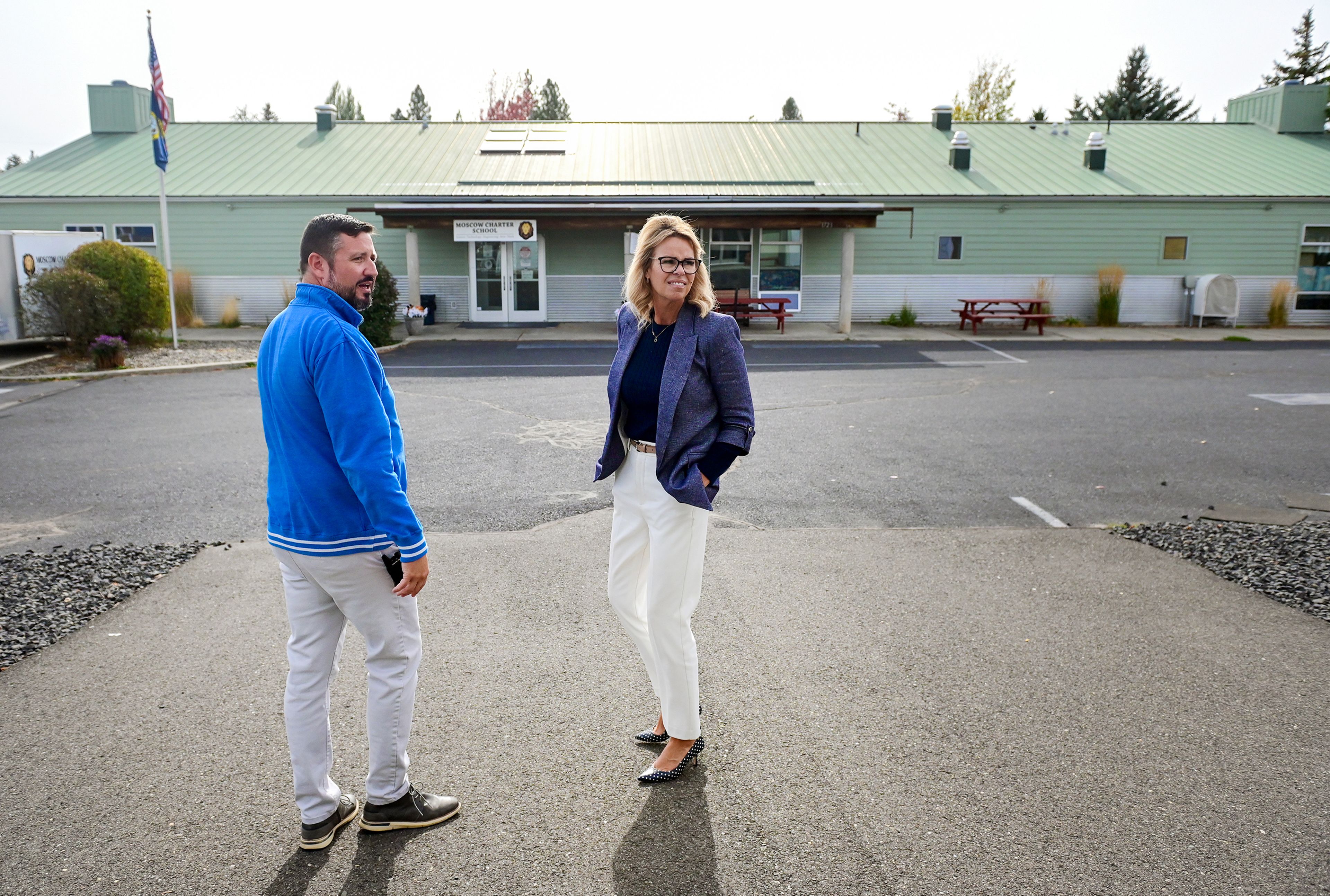 Moscow Charter School principal Tony Bonuccelli, left, walks Idaho Superintendent of Public Instruction Debbie Critchfield between school buildings during Critchfield�s tour of the school Friday in Moscow.