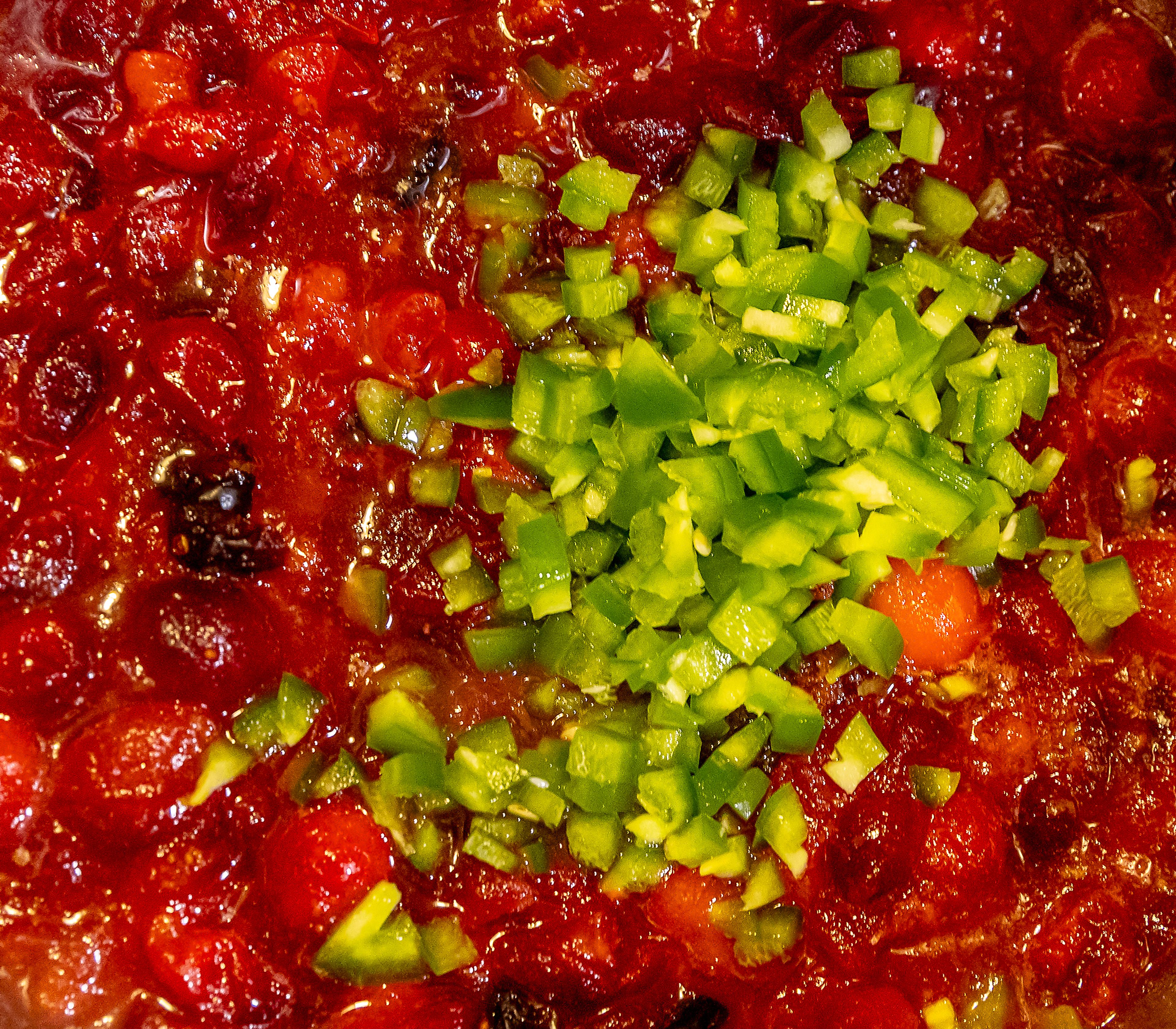 Peppers are added to cranberries Sunday in Lewiston.