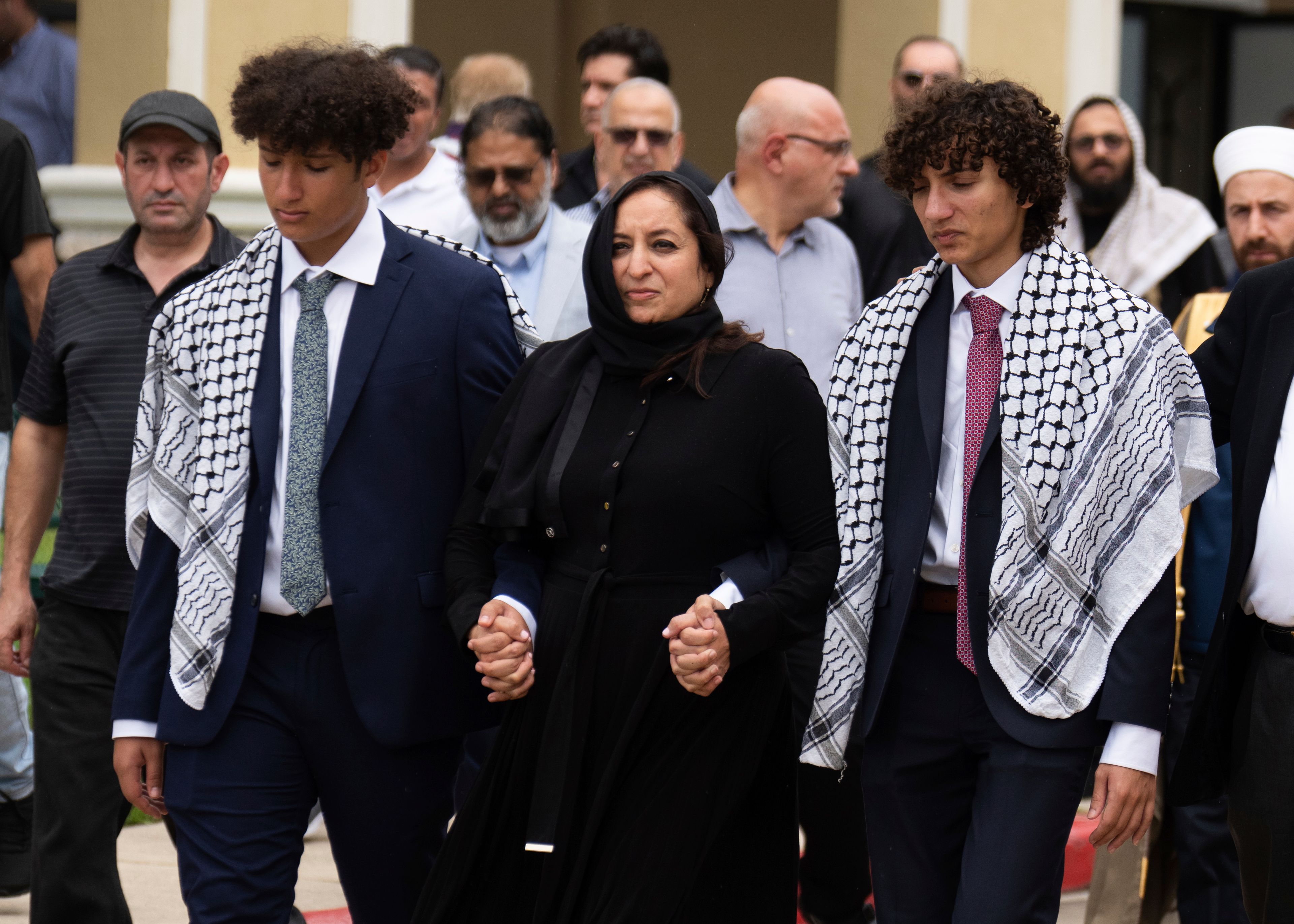 Jamila Al-Shami, wife of Harris County Precinct 4 Deputy Constable Maher Husseini, walks with her sons, Amin and Jamil Al-Husseini, after friends, family and law enforcement gathered funeral prayers at Masjid Al Salem Mosque, Thursday, Sept. 5, 2024, in Spring, Texas.