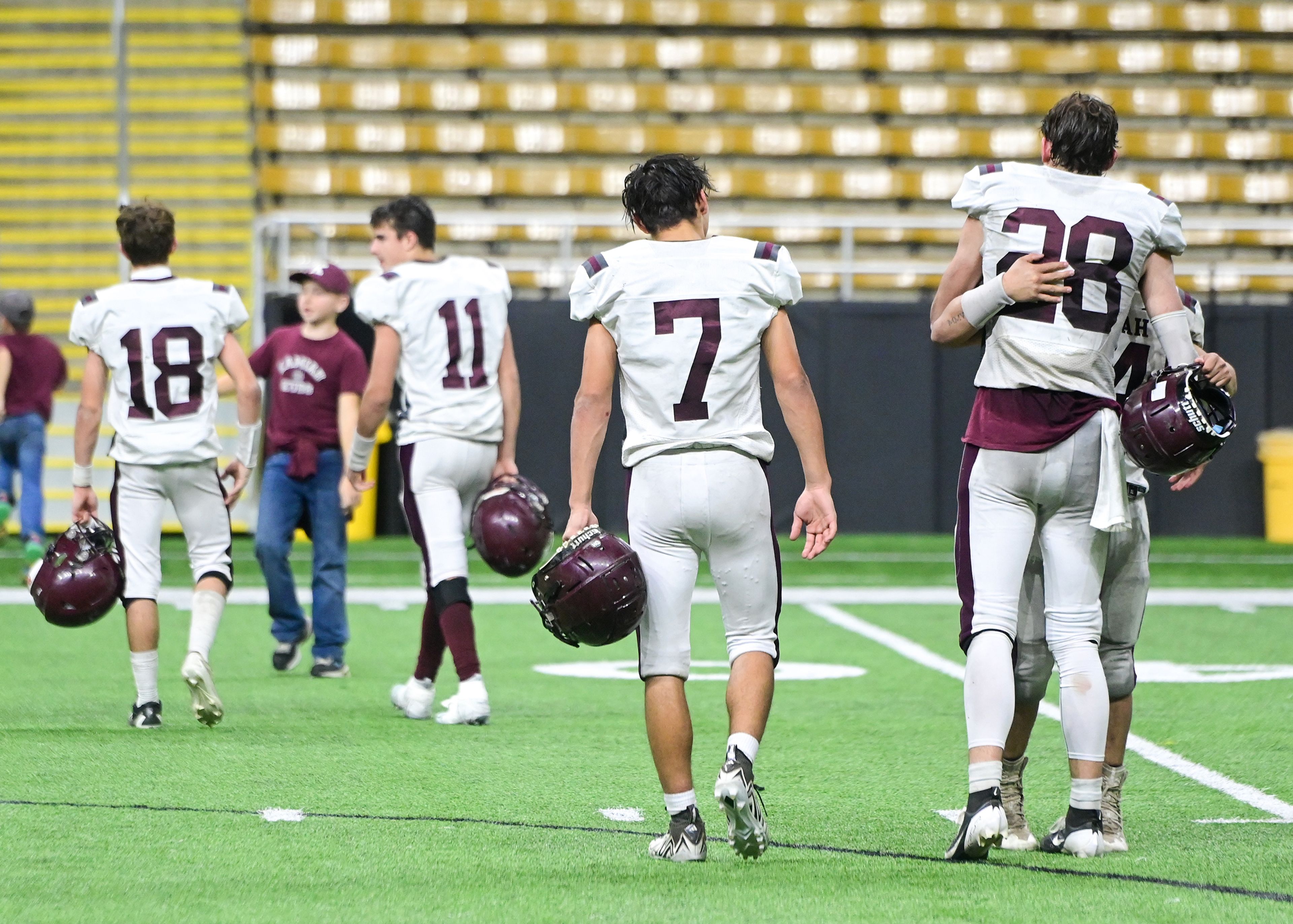 Kamiah players hug as they leave the field after their loss to Kendrick’s in an Idaho Class 2A state quarterfinal game at the P1FCU Kibbie Dome in Moscow.