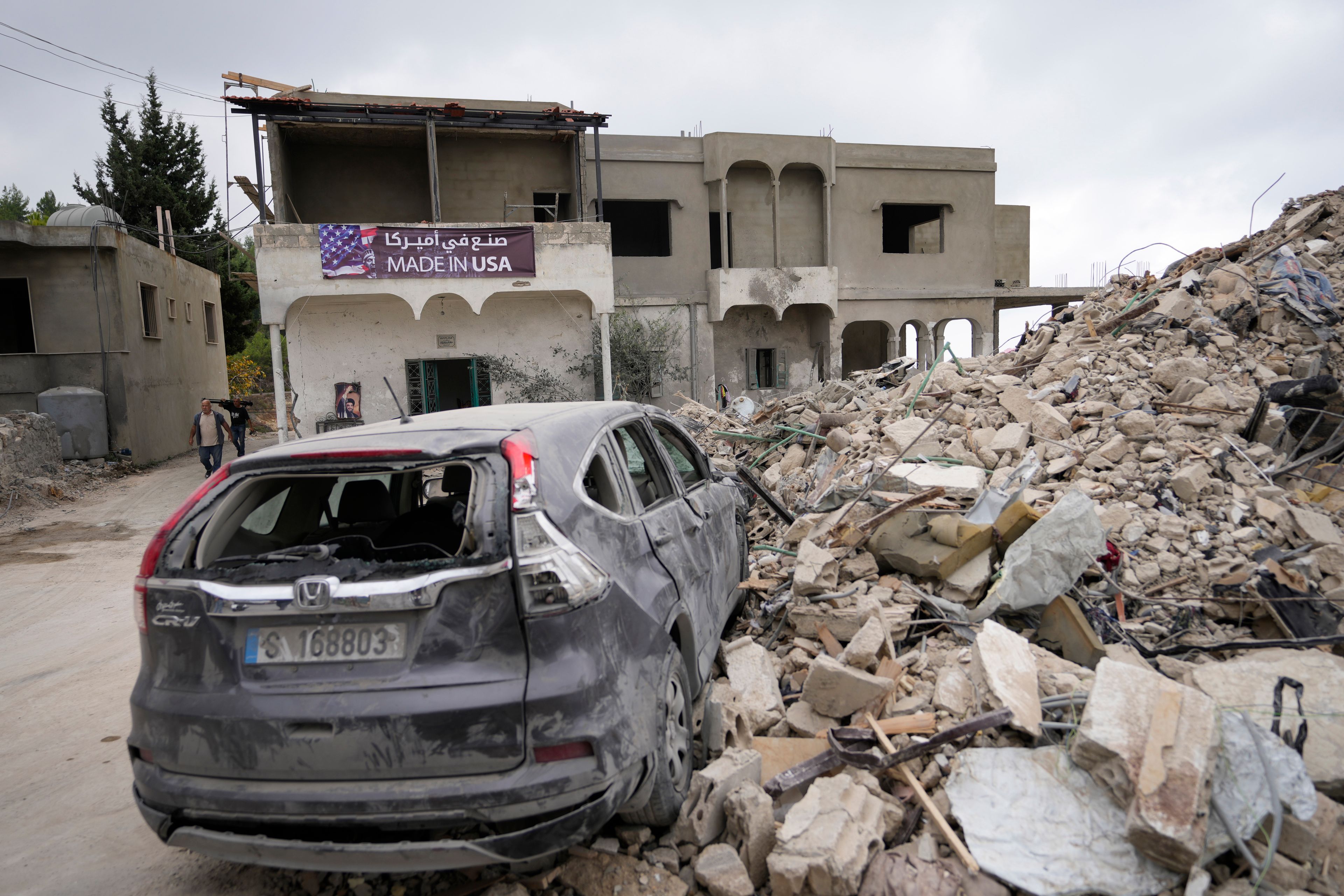 A car sits on the rubble of a building damaged in an Israeli airstrike, in Maisara near the northern coastal town of Byblos, Lebanon, Monday, Oct. 14, 2024. (AP Photo/Hassan Ammar)