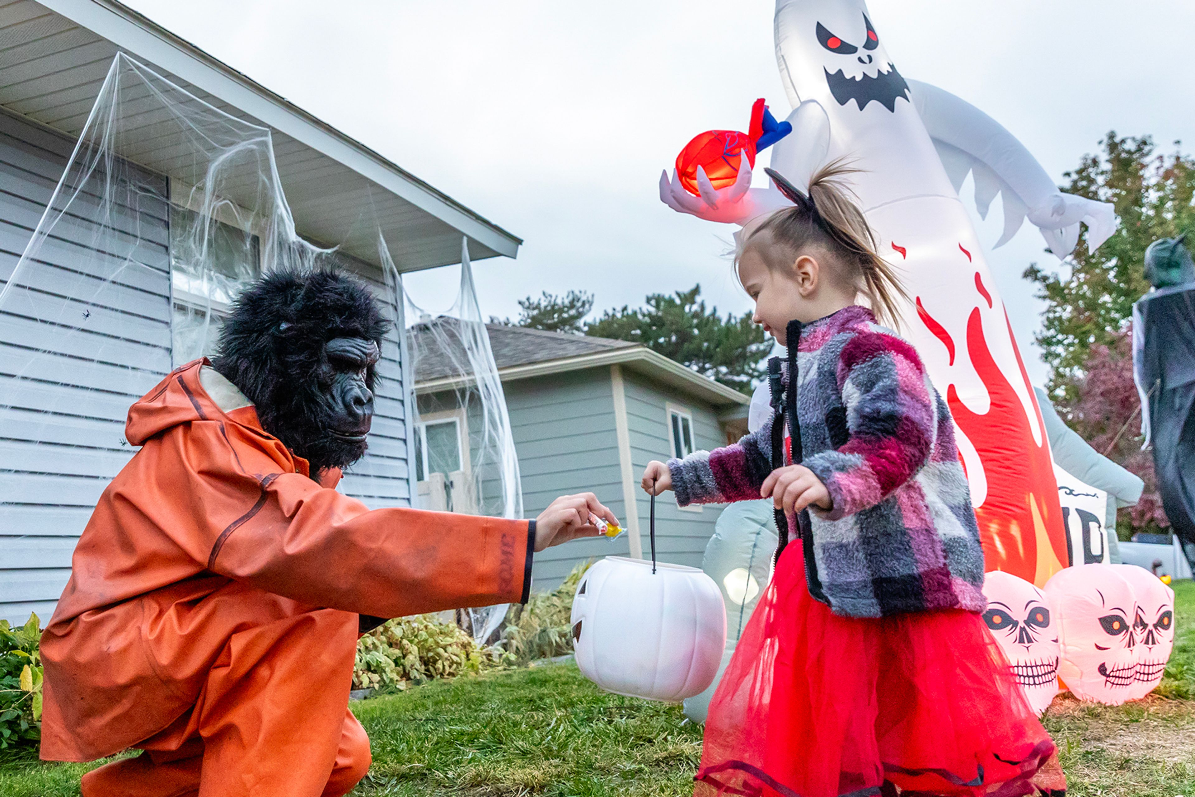 Heidi Rowell gives some candy to a trick-or-treater dressed as Minnie Mouse in the Sunset Drive neighborhood in Lewiston.