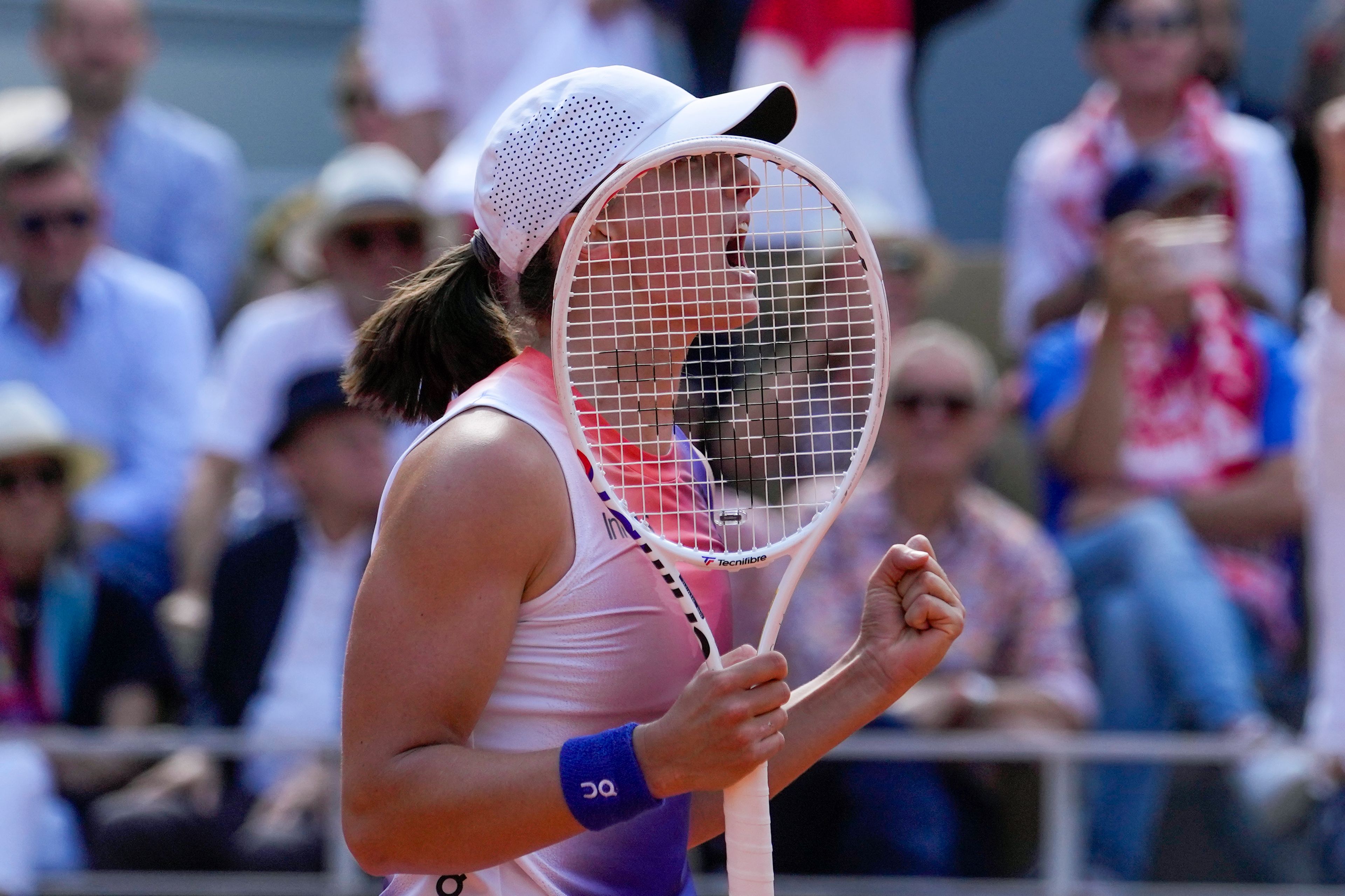 Poland's Iga Swiatek celebrates winning her semifinal match of the French Open tennis tournament against Coco Gauff of the U.S. at the Roland Garros stadium in Paris, Thursday, June 6, 2024.