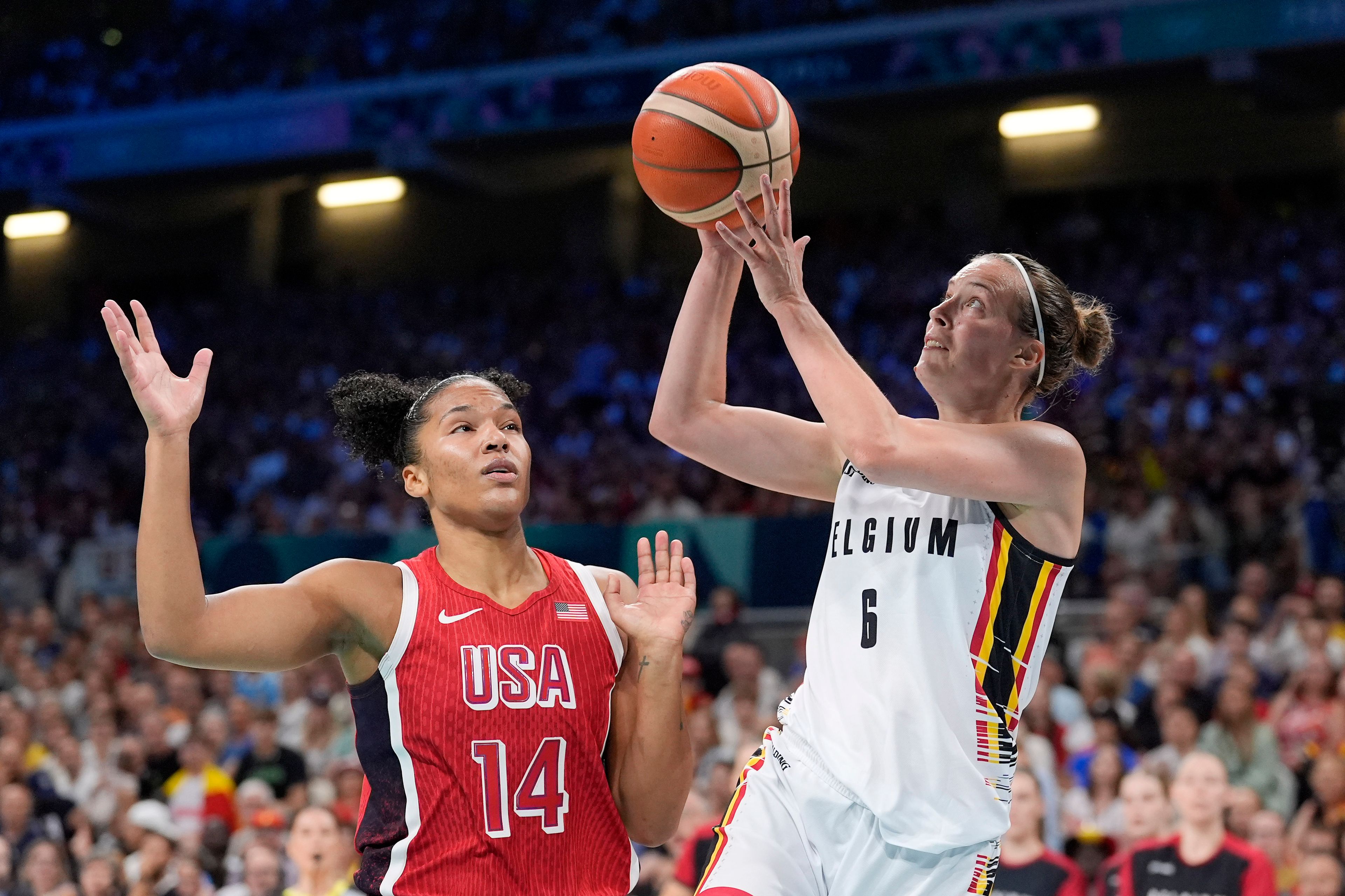 Belgium's Antonia Delaere, right, shoots as United States' Alyssa Thomas defends during a women's basketball game at the 2024 Summer Olympics, Thursday, Aug. 1, 2024, in Villeneuve-d'Ascq, France. (AP Photo/Michael Conroy)