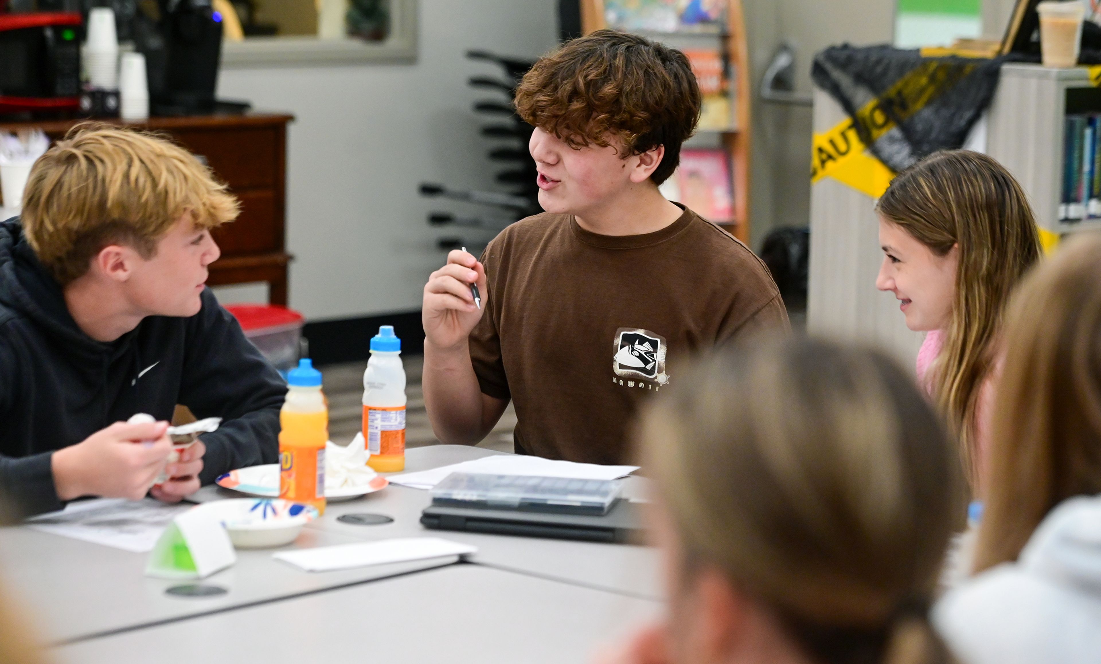 Asotin High School junior Spencer Conklin, left, freshman Gavin Hinkley, center, and freshman Adalyn Johnson, talk through ideas for a mission statement for the Students of the Valley Advocacy during a group meeting Monday at AHS.