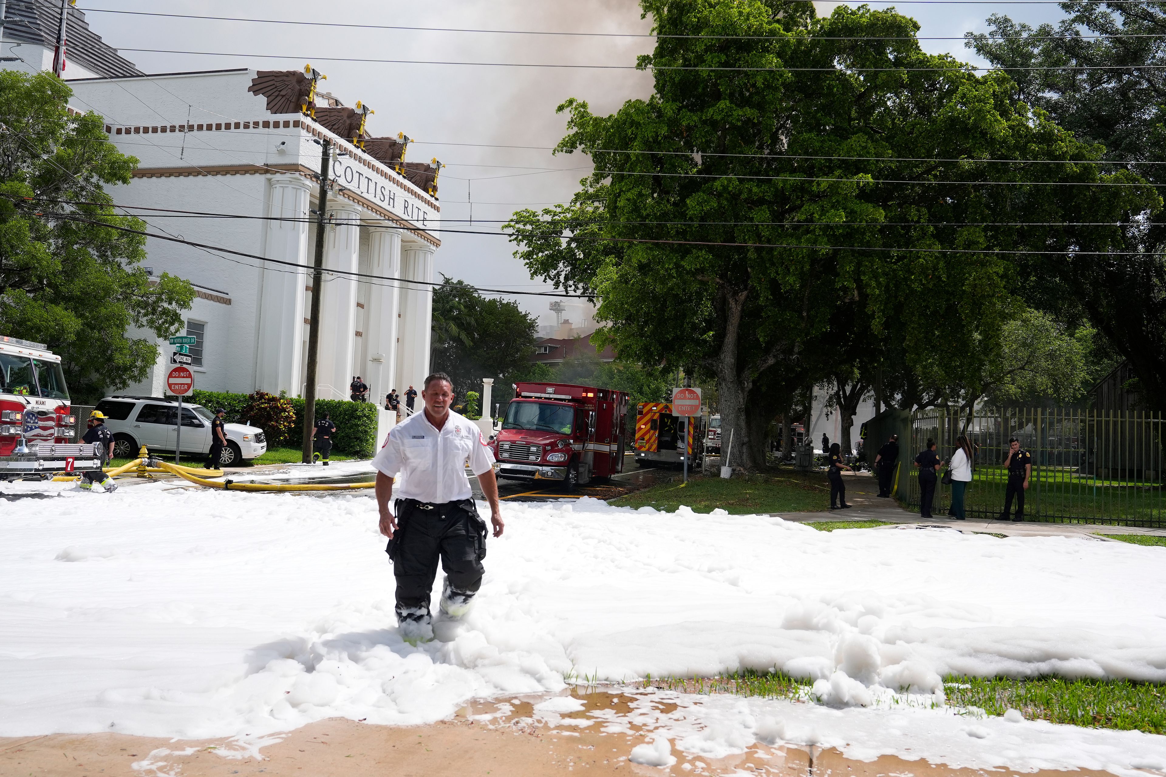 A City of Miami Fire Rescue firefighter walks from the scene of a fire at the Temple Court apartments Monday, June 10, 2024, in Miami.