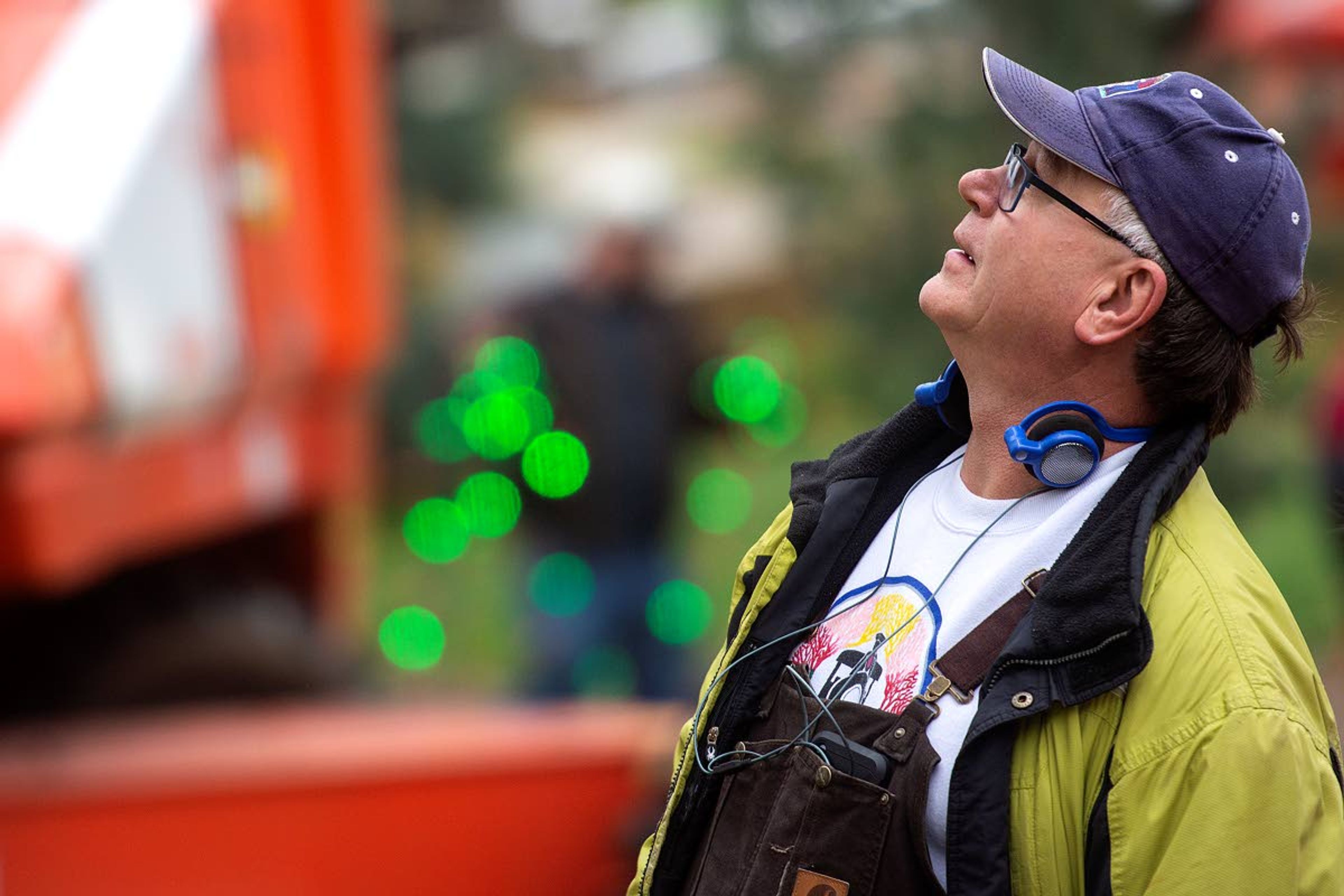 Larry Kopczynski looks up at the musical tree, the centerpiece of the Winter Spirit light display, as his fellow volunteers begin to cover all the Locomotive Park foliage with decorative lights on Saturday morning in Lewiston.