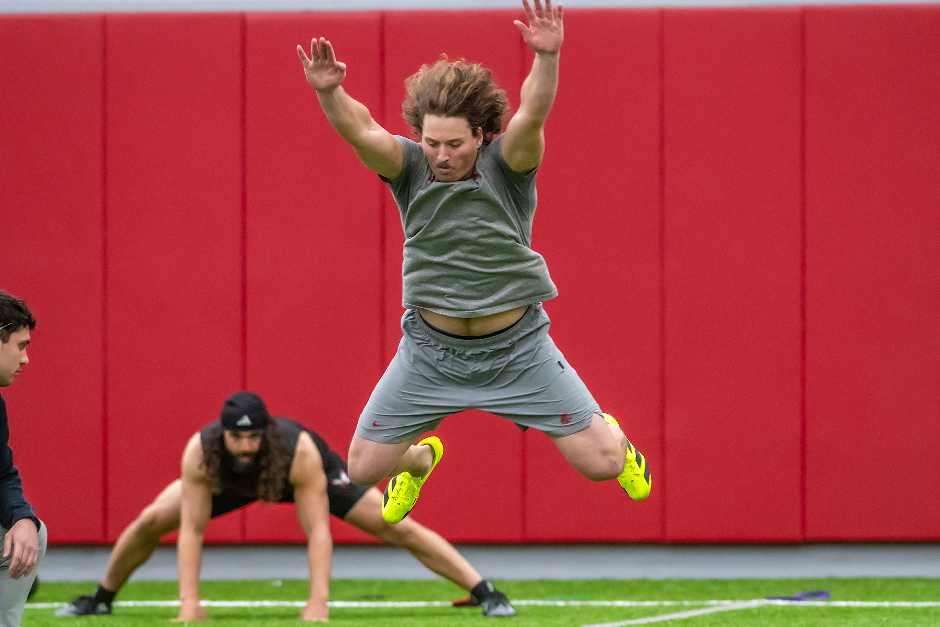 Washington State defensive end Andrew Edson leaps forward for the broad jump test during WSU's Pro Day on Friday in Pullman.