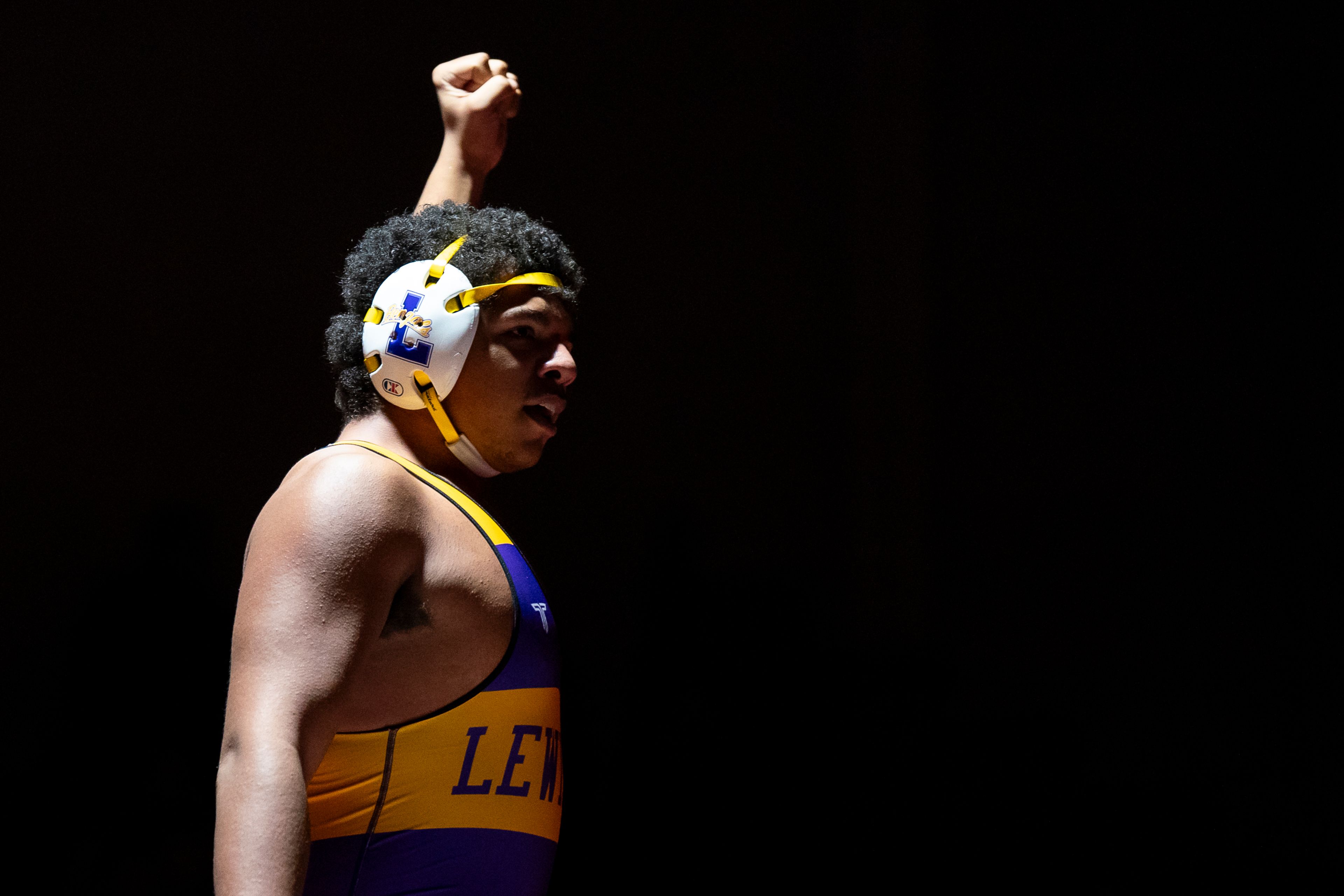 Lewiston’s King David Rhodes raises his hand after winning his 285-pound match against Clarkston’s Justyn Watters Wednesday at Kramer Gym in Clarkston.