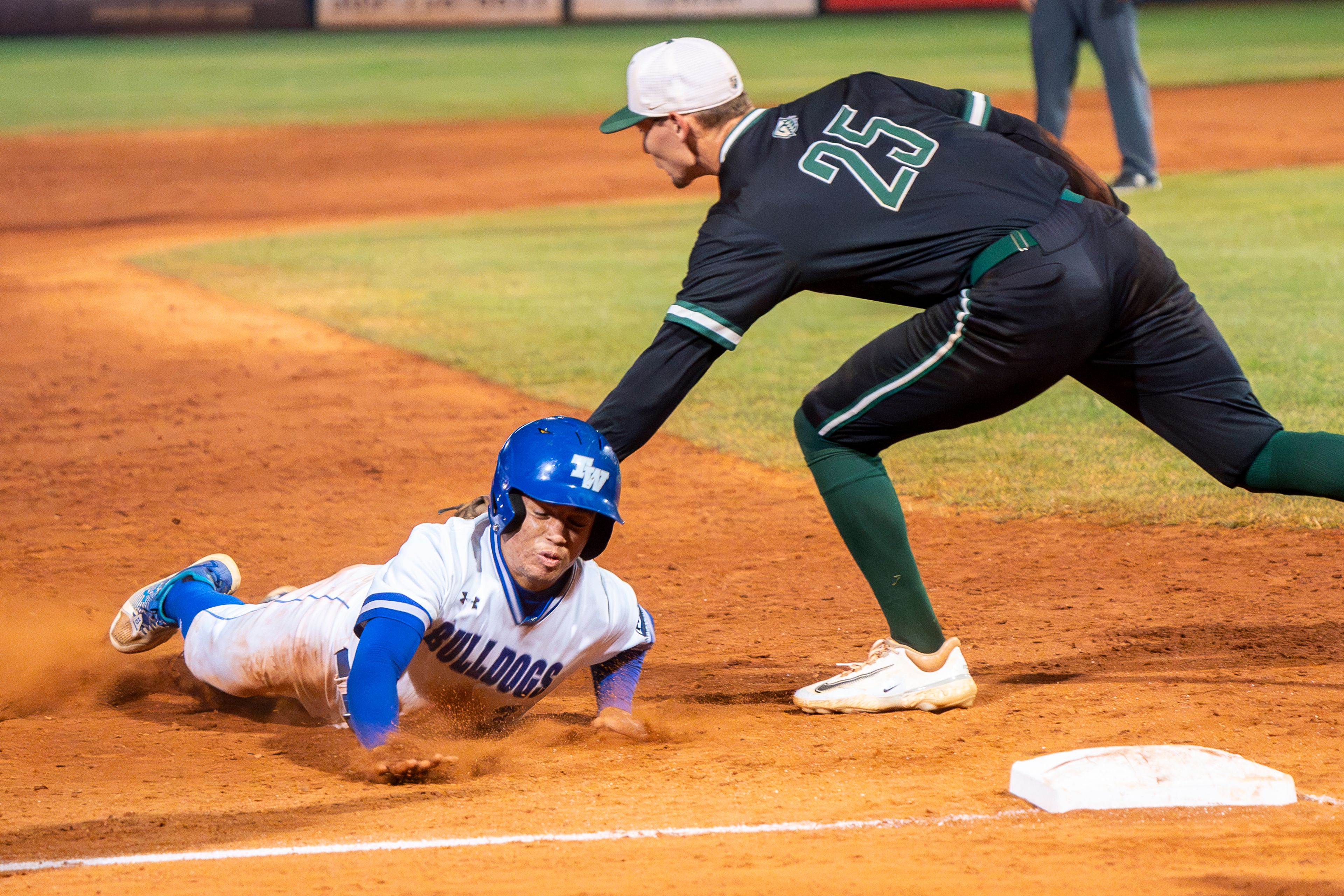 Tennessee Wesleyan’s Dante Leach (3) is tagged out by Georgia Gwinnett’s Paul Winland Jr. (25) after attempting to steal third base during Game 12 of the NAIA World Series on Monday at Harris Field in Lewiston.