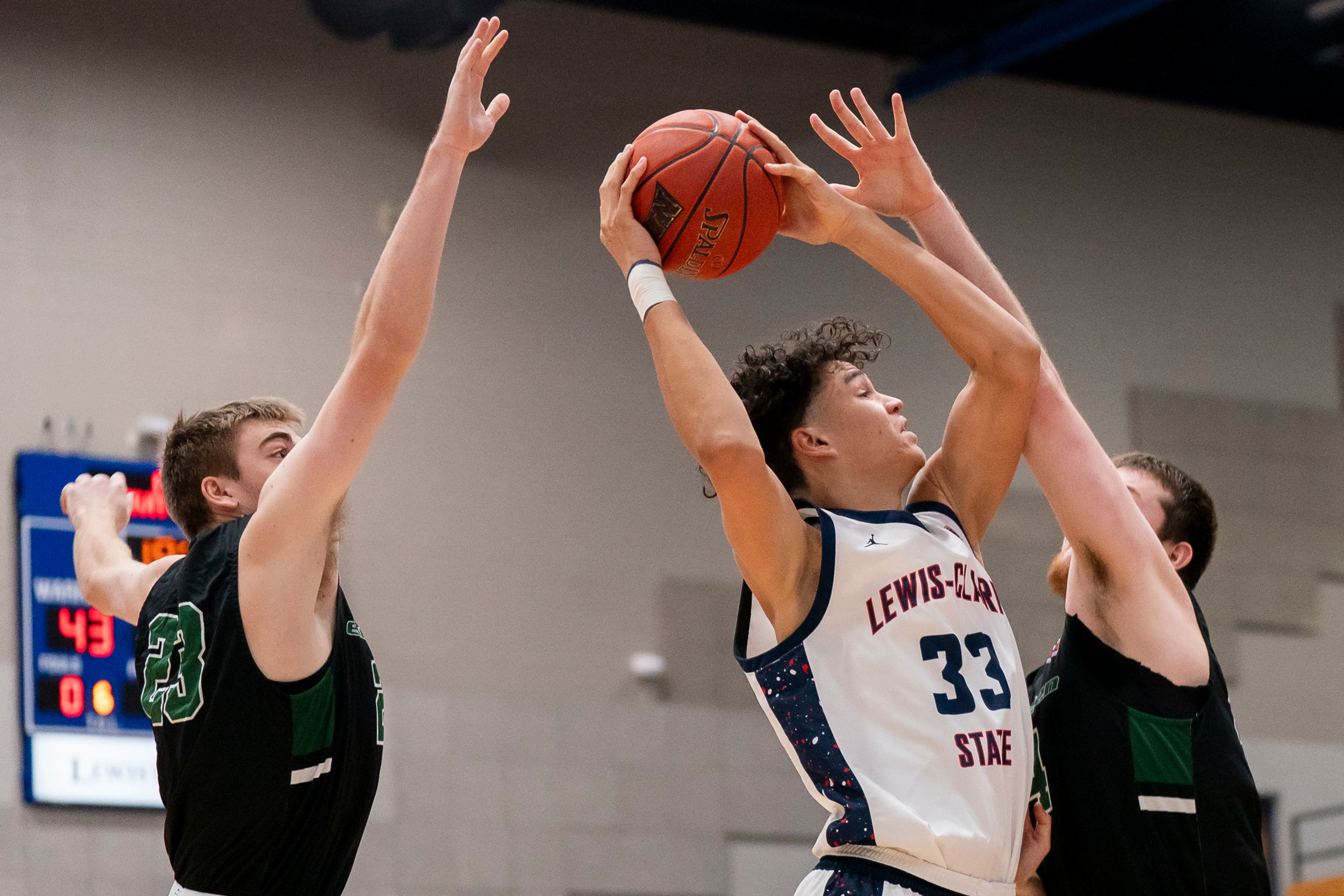 Lewis-Clark State College forward Alton Hamilton, center, goes up for a shot during a game against Evergreen State on Dec. 1 at the P1FCU Activity Center in Lewiston.