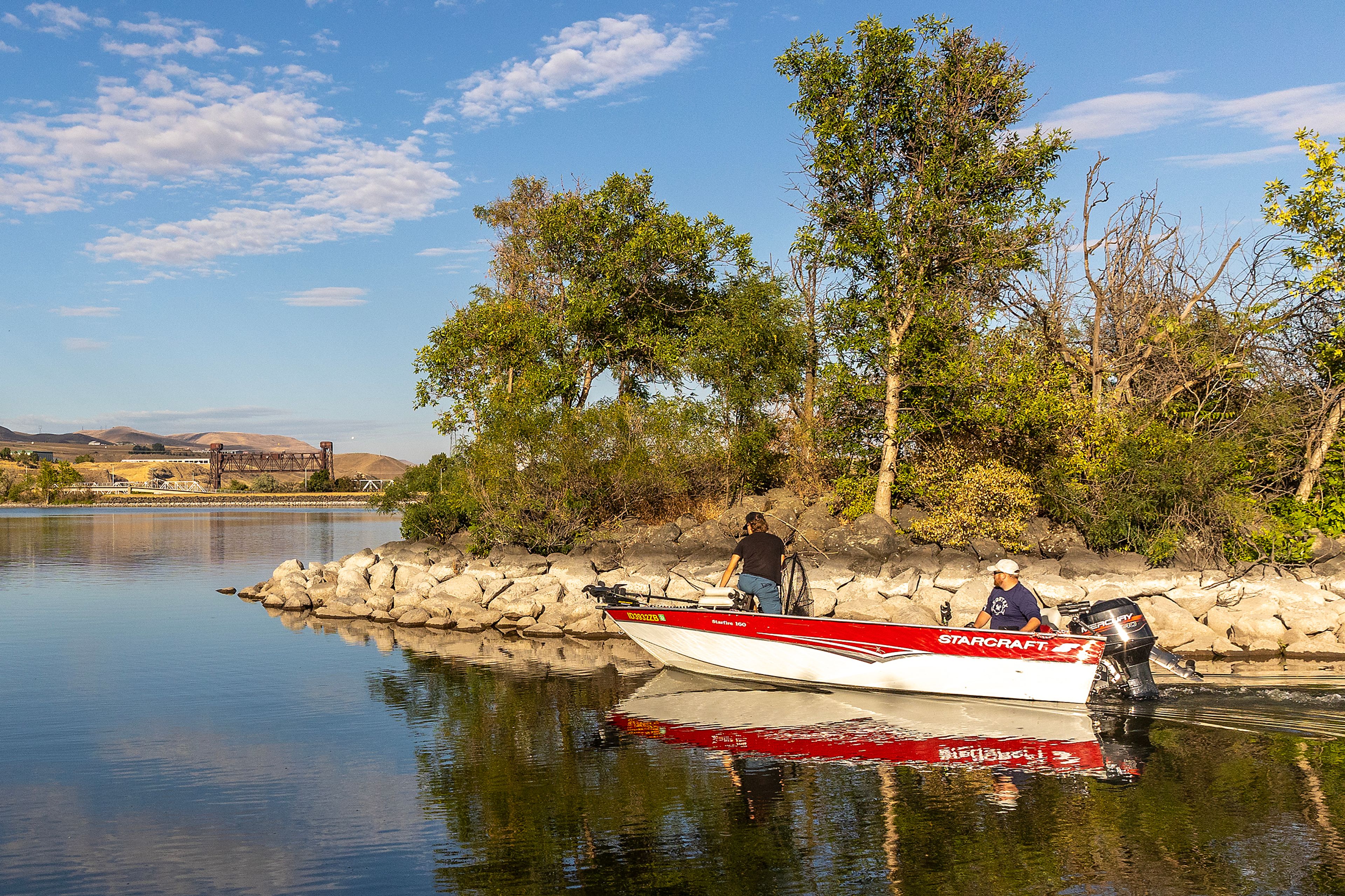 A boat makes its way through the mouth at the Greenbelt Boat Launch onto the confluence Wednesday evening in Clarkston.