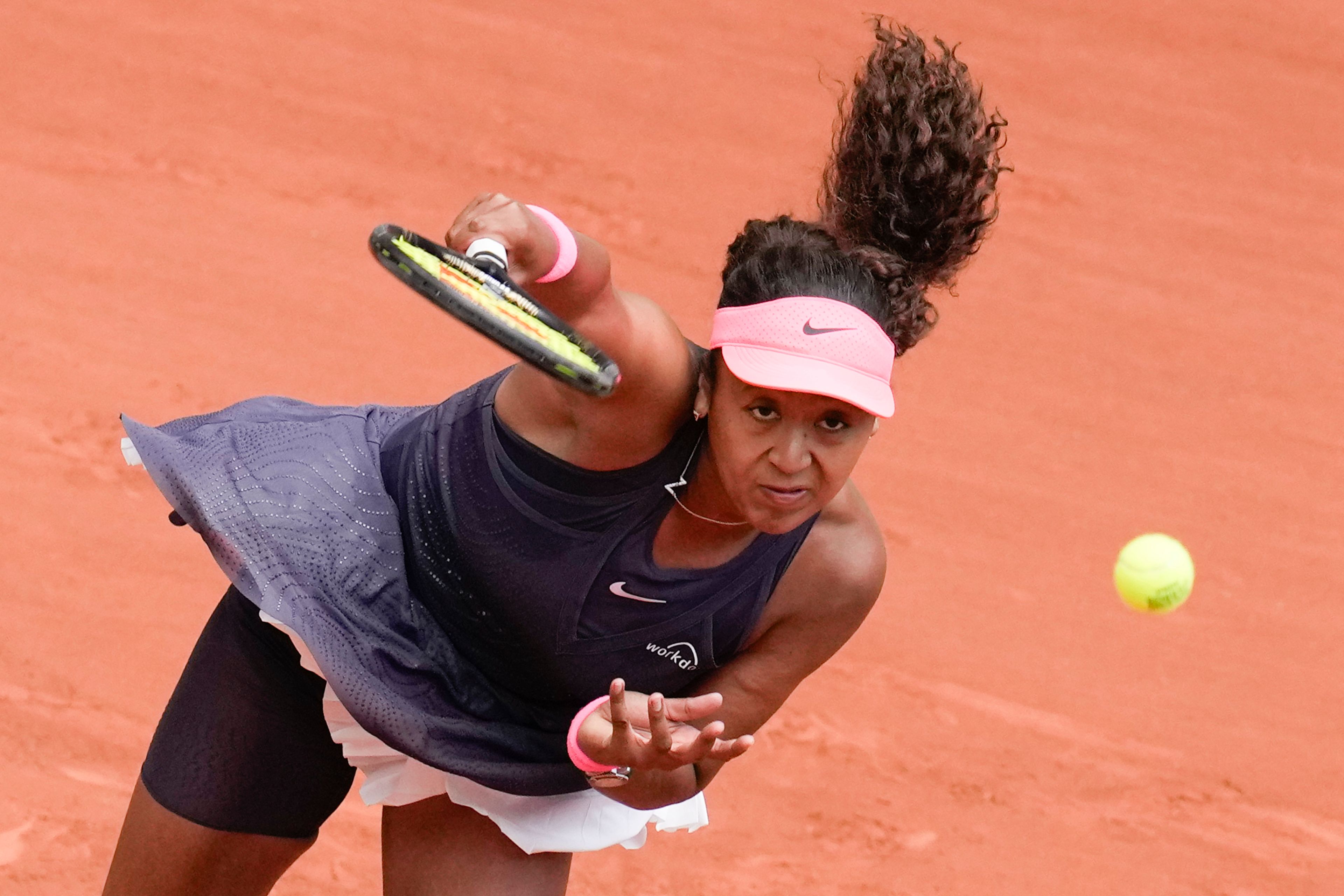 Japan's Naomi Osaka serves against Italy's Lucia Bronzetti during their first round match of the French Open tennis tournament at the Roland Garros stadium in Paris, Sunday, May 26, 2024.