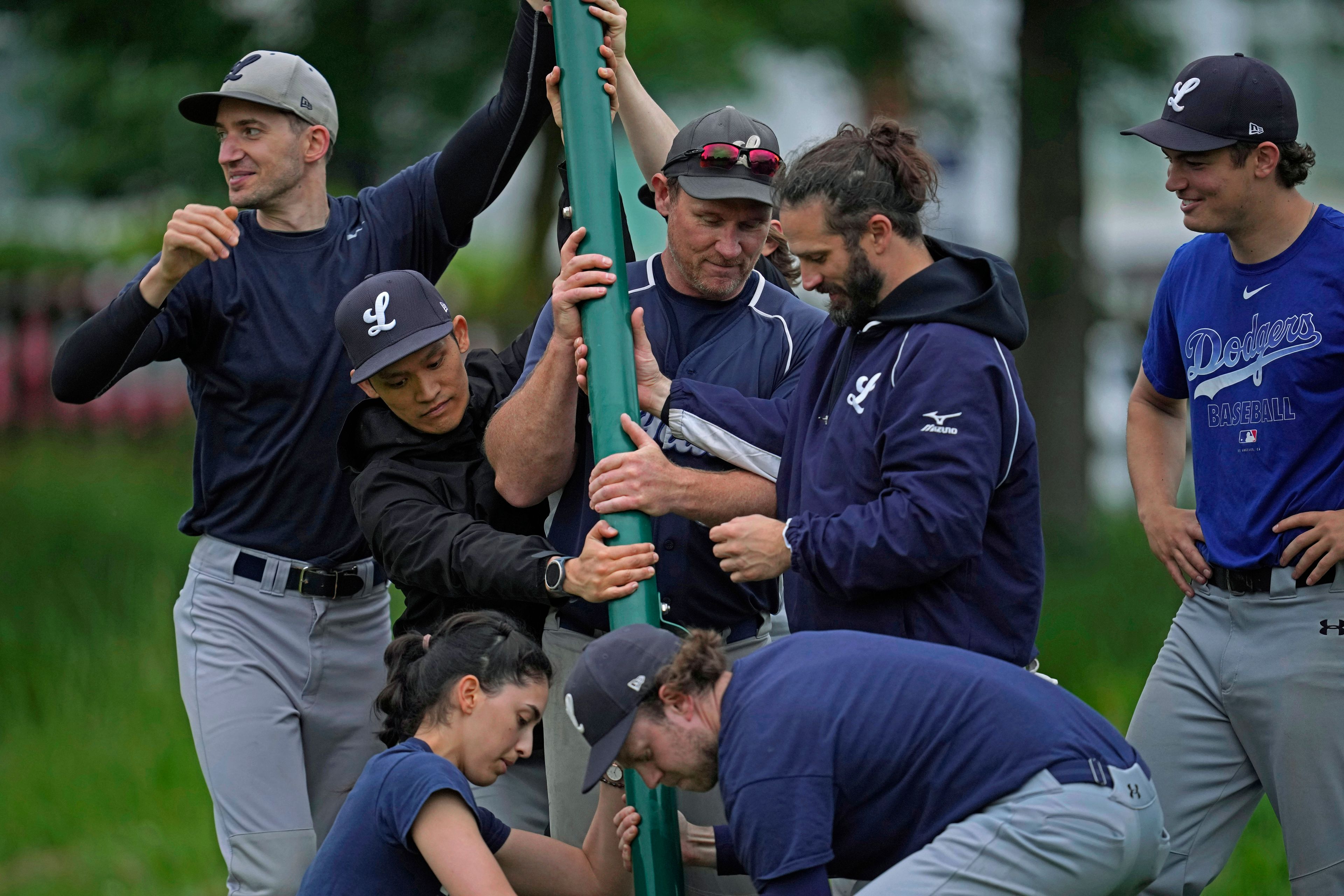 Members of the UK baseball team London Mets setup a net during a training session at the Finsbury Park in London, Thursday, May 16, 2024. Baseball at the highest club level in Britain is competitive. Teams are mélange of locals and expats some with college and minor league experience.