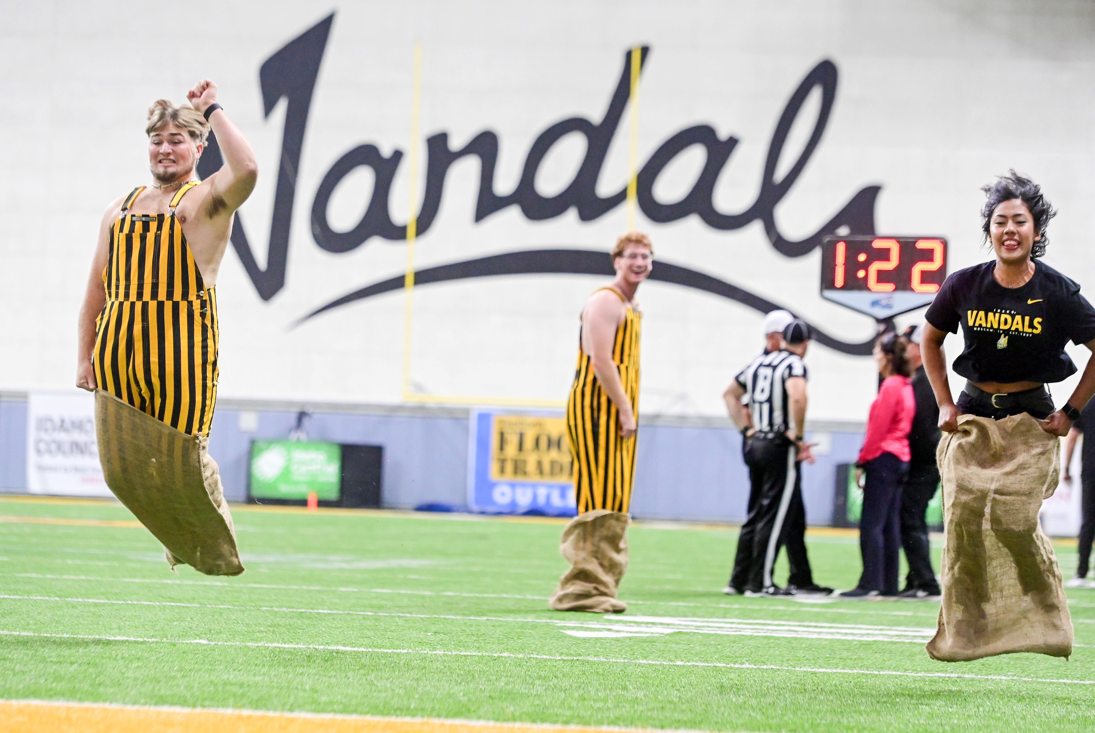 University of Idaho students Ethan Hedgpeth, left, and Roxana Bolanos, right, compete in a potato sack race for a Vandal Prize Pack during a time out in the Idaho vs. Cal Poly game Saturday at the P1FCU Kibbie Dome in Moscow. Bolanos and her teammate William Hanosky, not pictured, came out on top.,