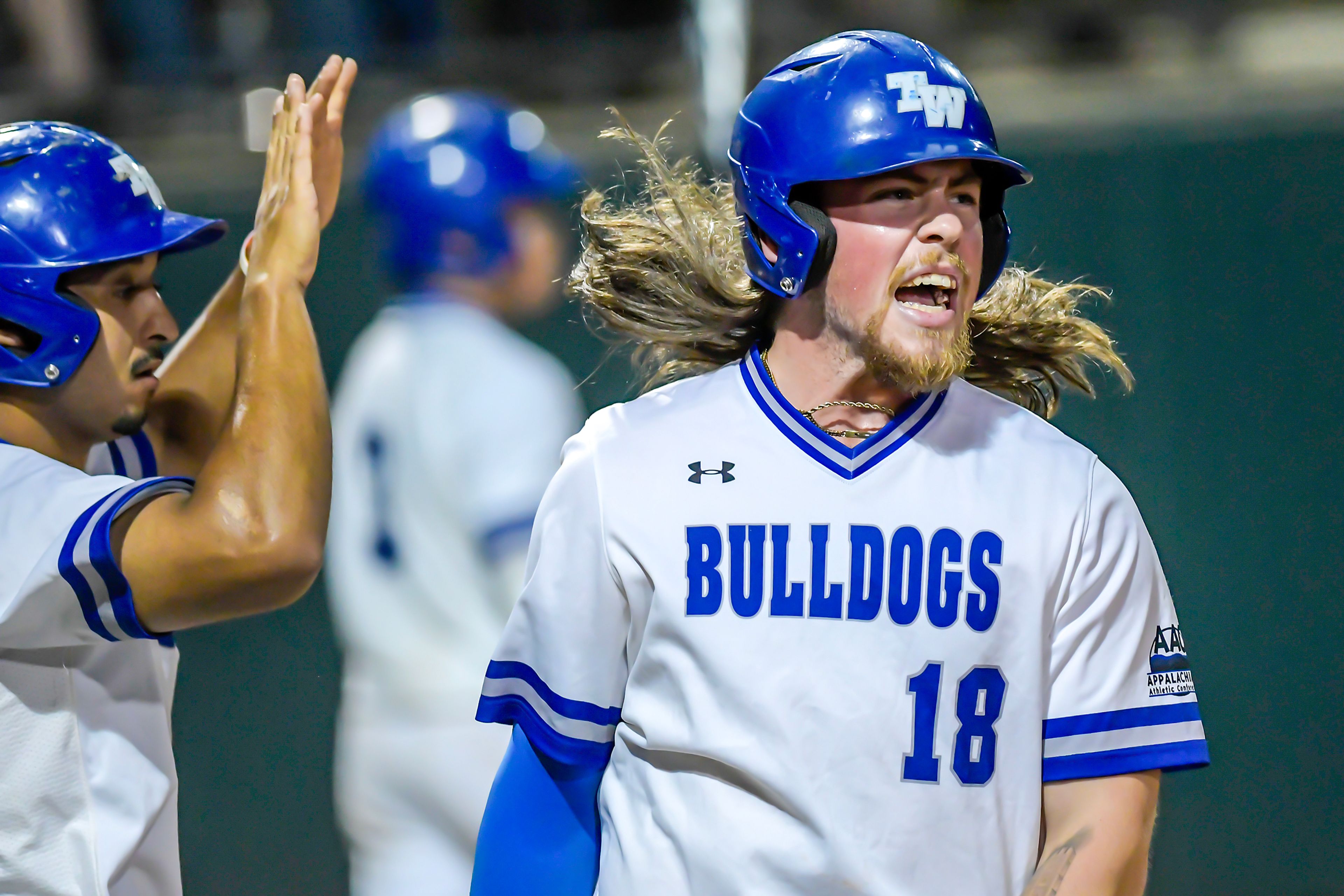 Tennessee Wesleyan’s Evan Magill lets out a yell as he comes through home to score against Georgia Gwinnett in Game 12 of the NAIA World Series at Harris Field Monday in Lewiston.