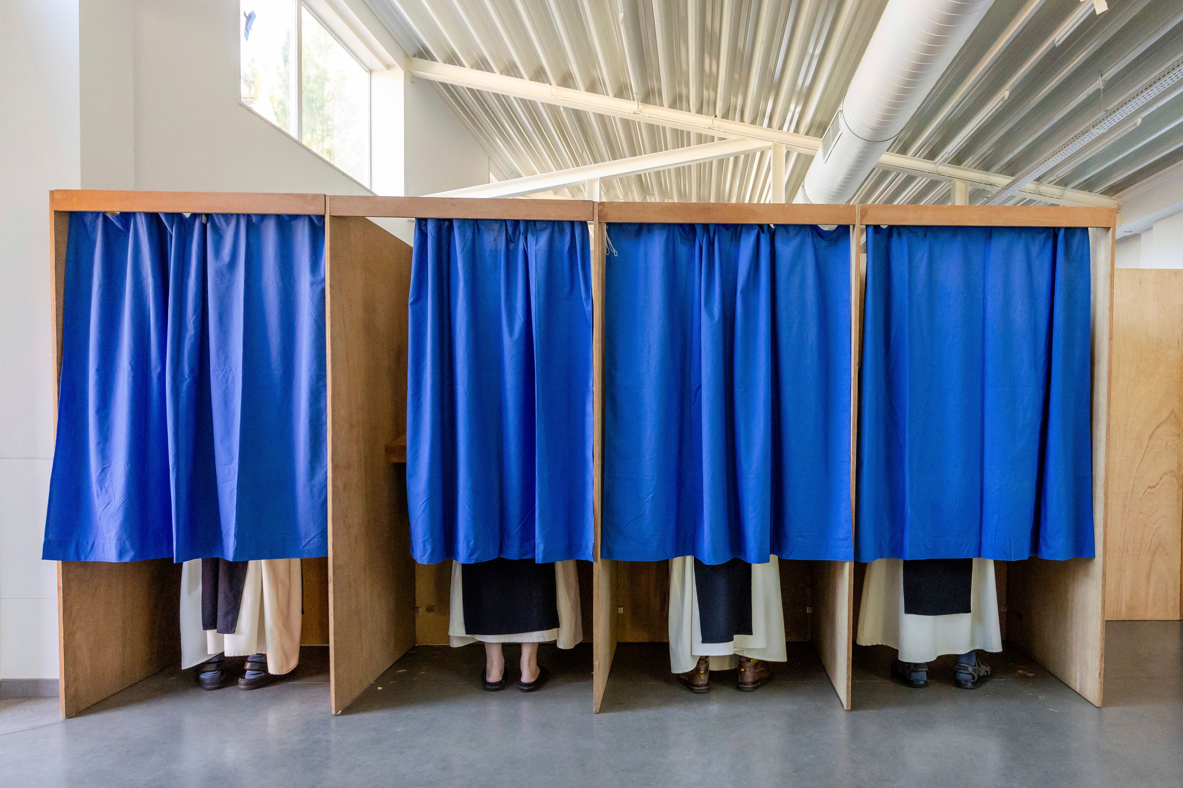 Monks from the Sint-Sixtus Abbey stand in booths to cast their votes in Vleteren, Belgium, Sunday, June 9, 2024. Polling stations opened across Europe on Sunday as voters from 20 countries cast ballots in elections that are expected to shift the European Union's parliament to the right and could reshape the future direction of the world's biggest trading bloc.