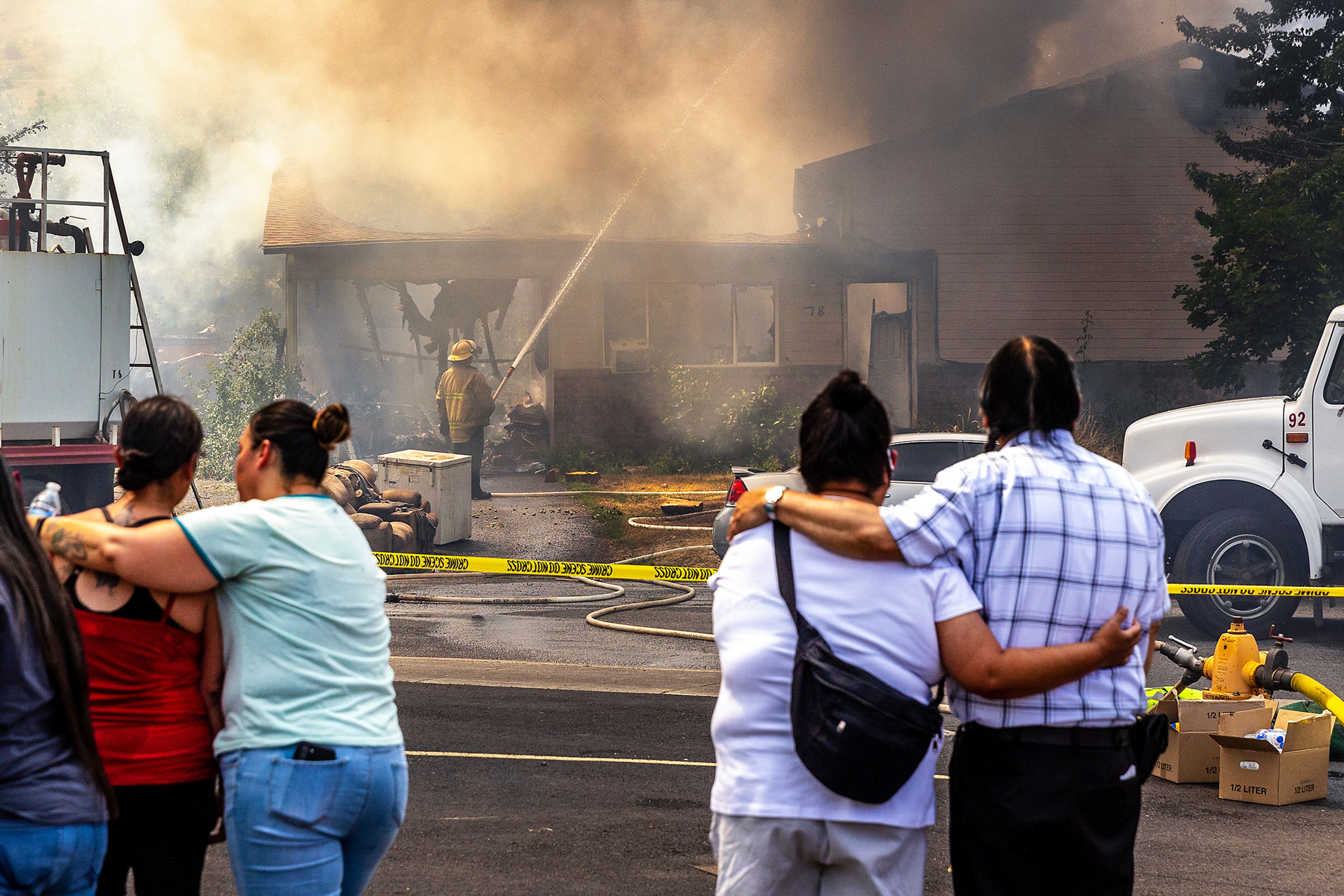 People look on at the scene of a structure fire Friday on Lolo Street in Lapwai.