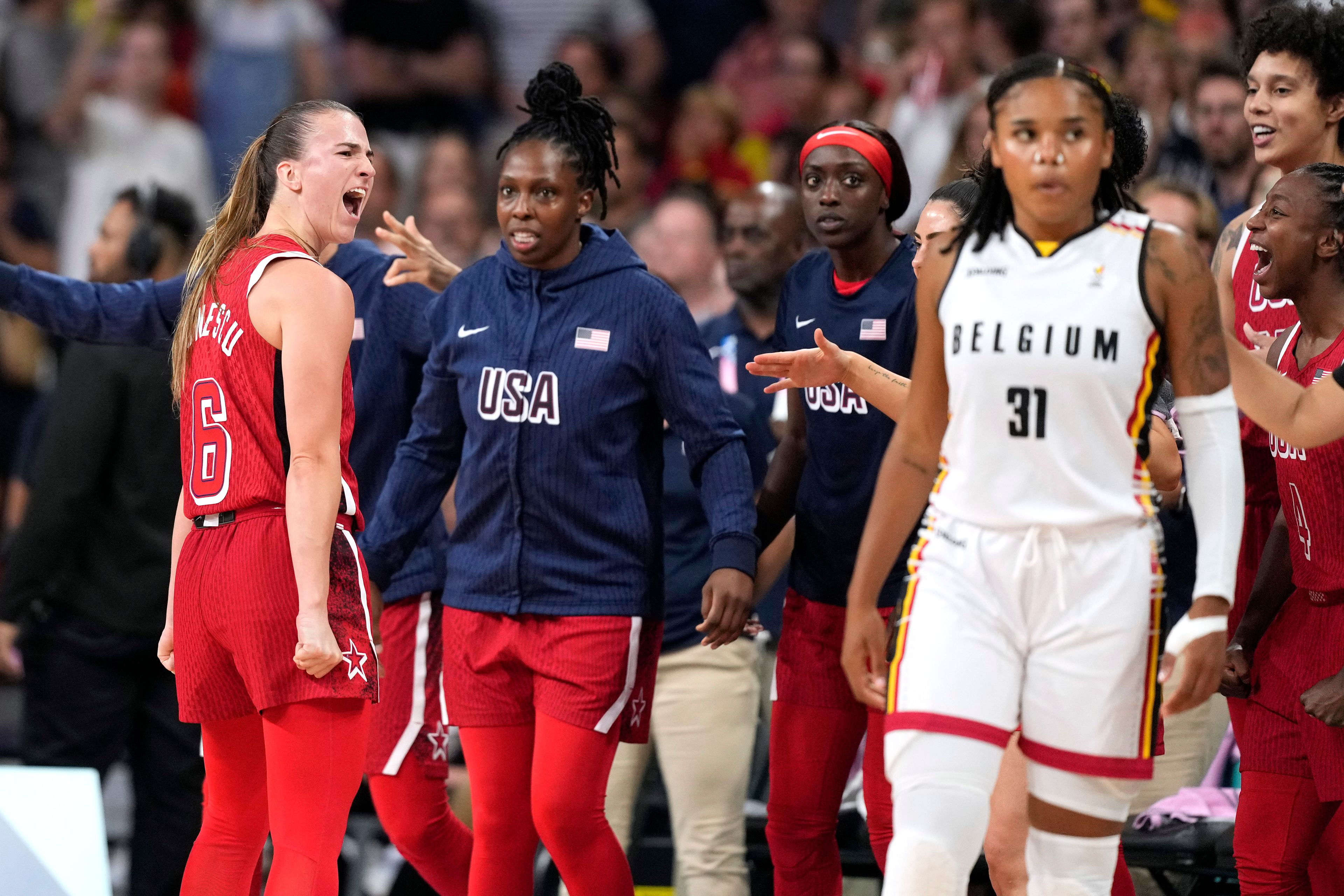 United States' Sabrina Ionescu, left, celebrates as Belgium's Maxuella Lisowa-Mbaka, right, walks away after the United States defeated Belgium in a women's basketball game at the 2024 Summer Olympics, Thursday, Aug. 1, 2024, in Villeneuve-d'Ascq, France. (AP Photo/Michael Conroy)