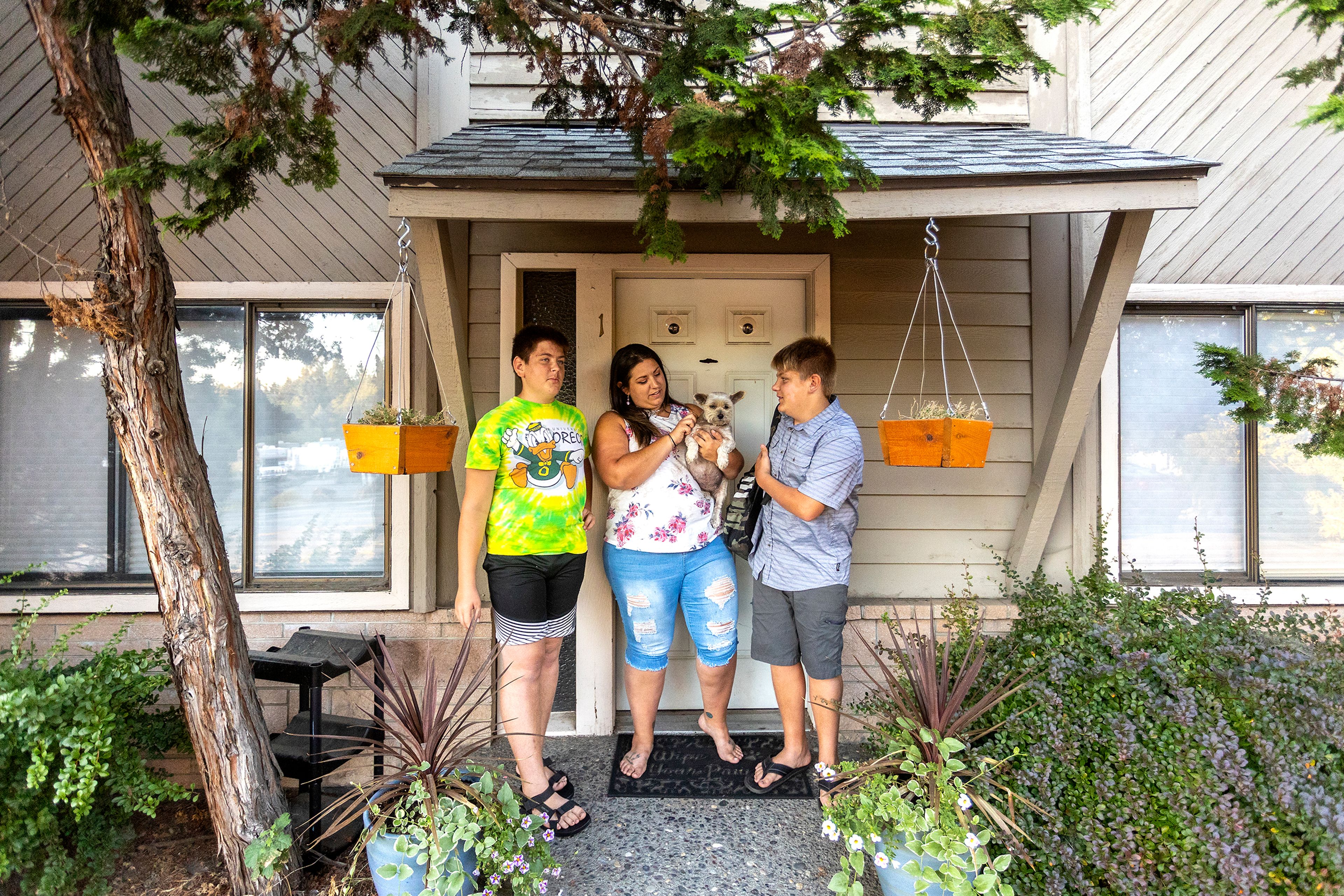 Alex Poulsen, from left, Aimee Martinez, Gracie and Tony Poulsen stand outside their front door before heading to the Moscow High School football game on Friday.