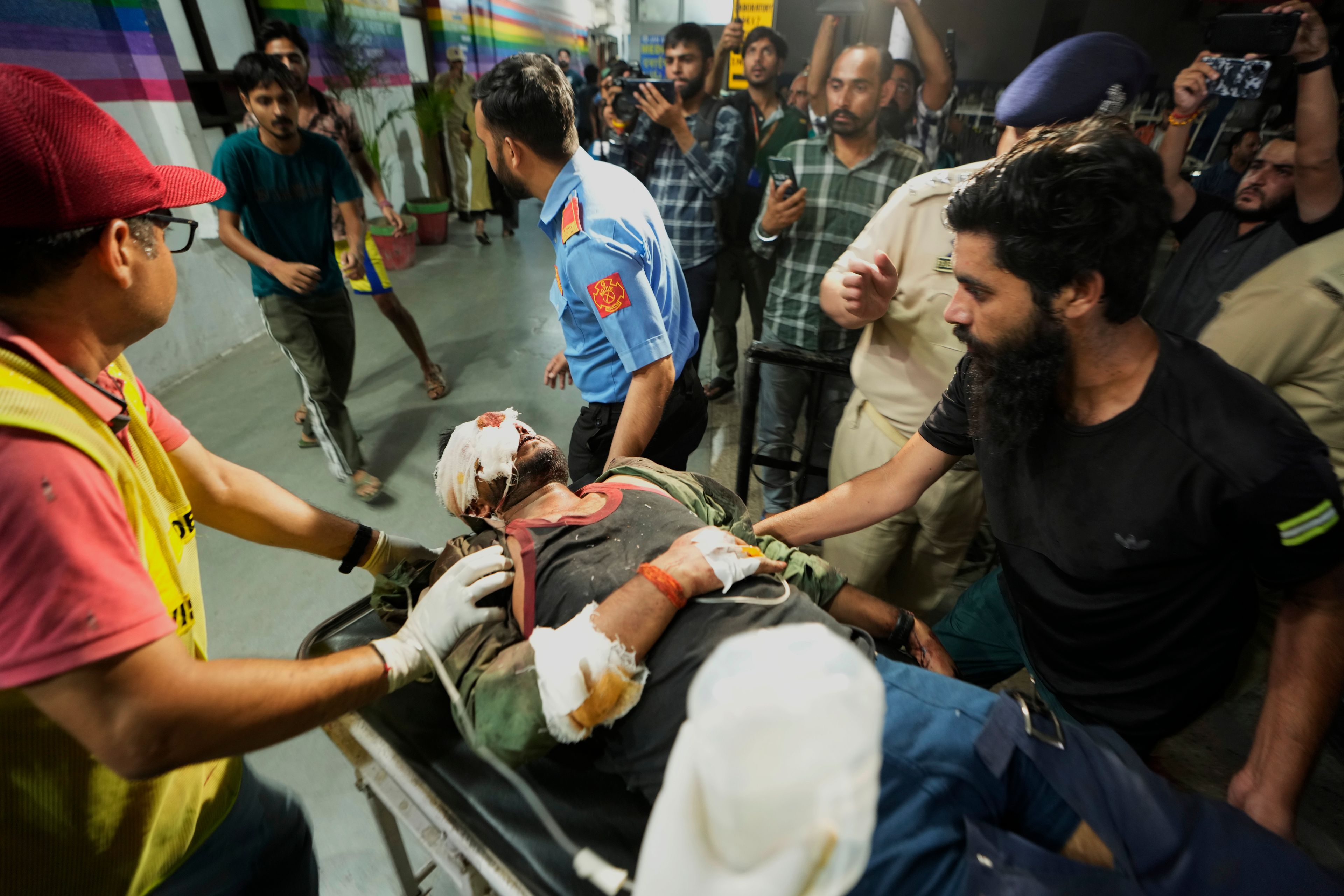 An injured man is brought to the Government Medical College Hospital in Jammu after the bus he was traveling in fell into a deep gorge in the Pouni area of Jammu's Reasi district, India, Sunday, June 9, 2024. Officials in Indian-controlled Kashmir say at least nine people have been killed after suspected militants fired at a bus with Hindu pilgrims, which then fell into a deep gorge.