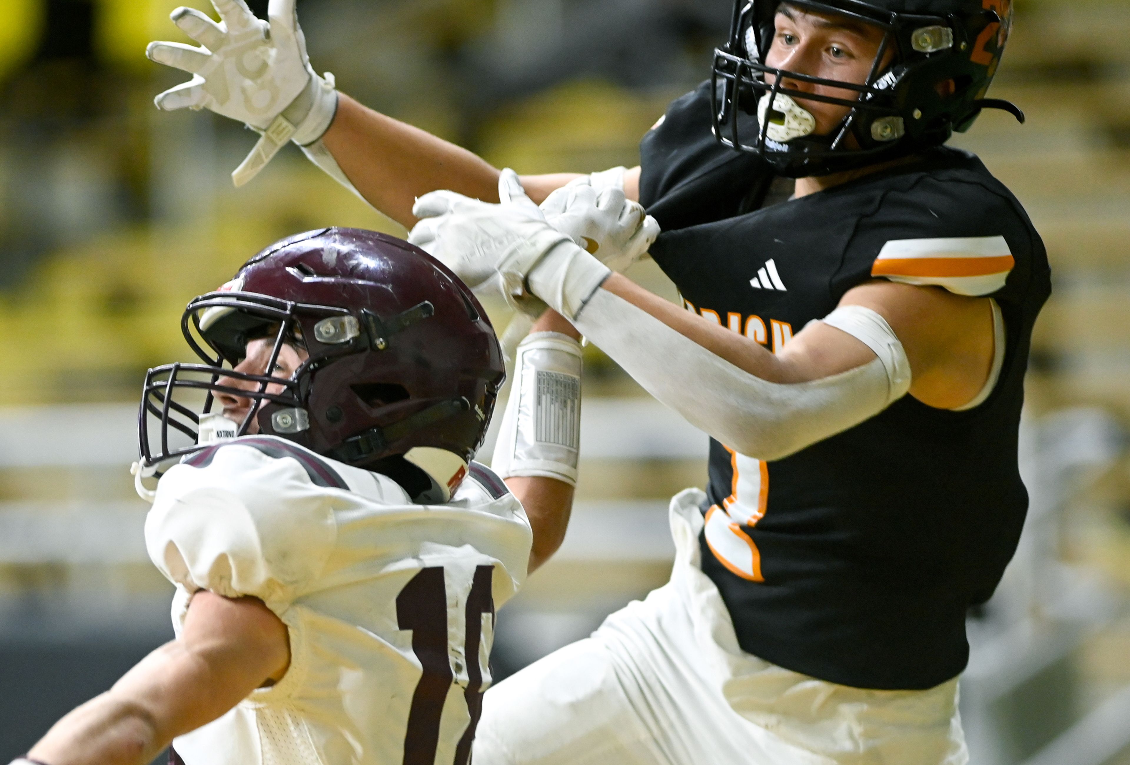 Kamiah’s Todd Roberts blocks Kendrick’s Ralli Roetcisoender from a pass during an Idaho Class 2A state quarterfinal game at the P1FCU Kibbie Dome in Moscow.