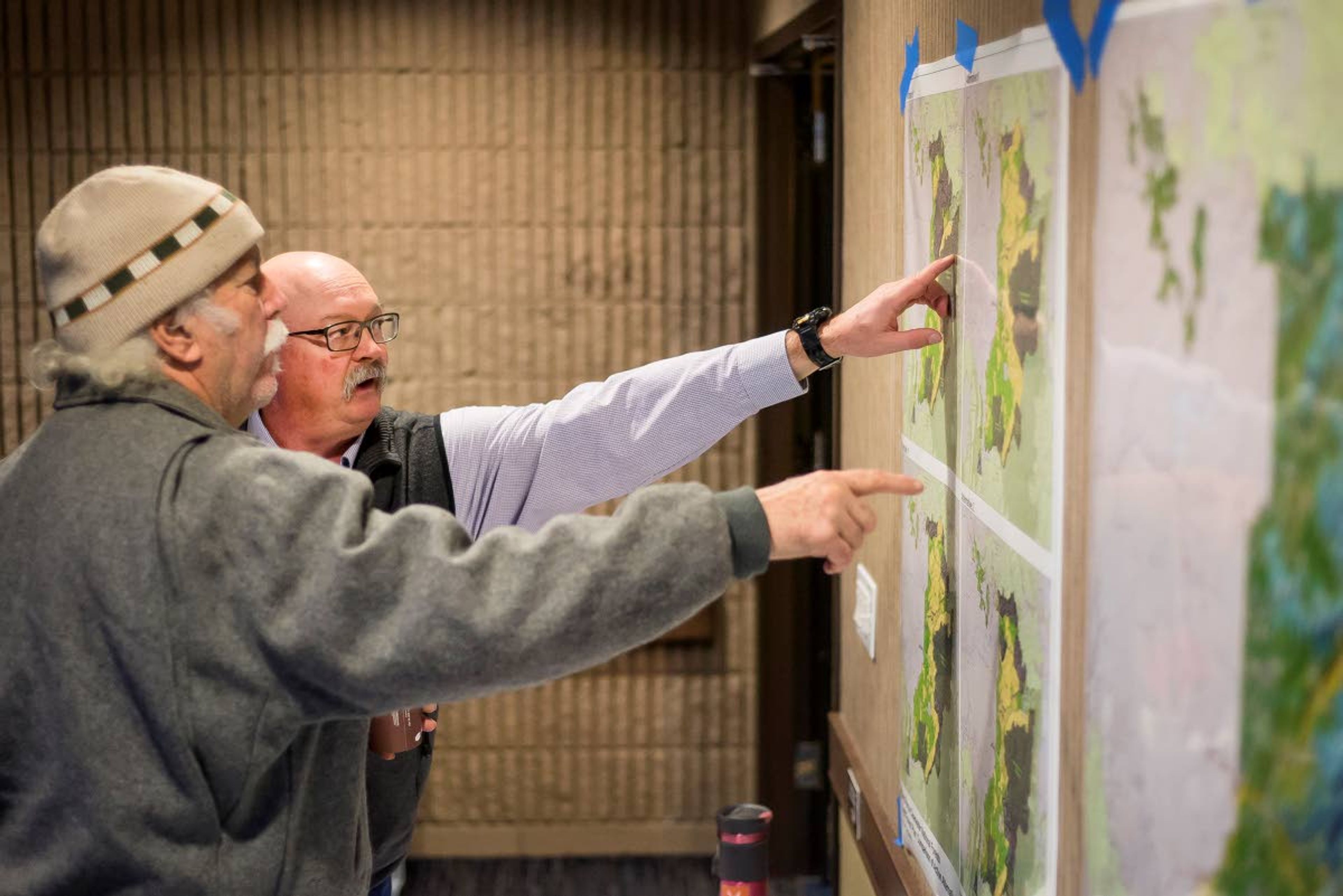 Nez Perce-Clearwater National Forest vegetation management specialist Buddie Carrol (right) points out different areas on the map to a member of the public during a meeting Saturday about the draft forest plan at Best Western Plus University Inn at Moscow.