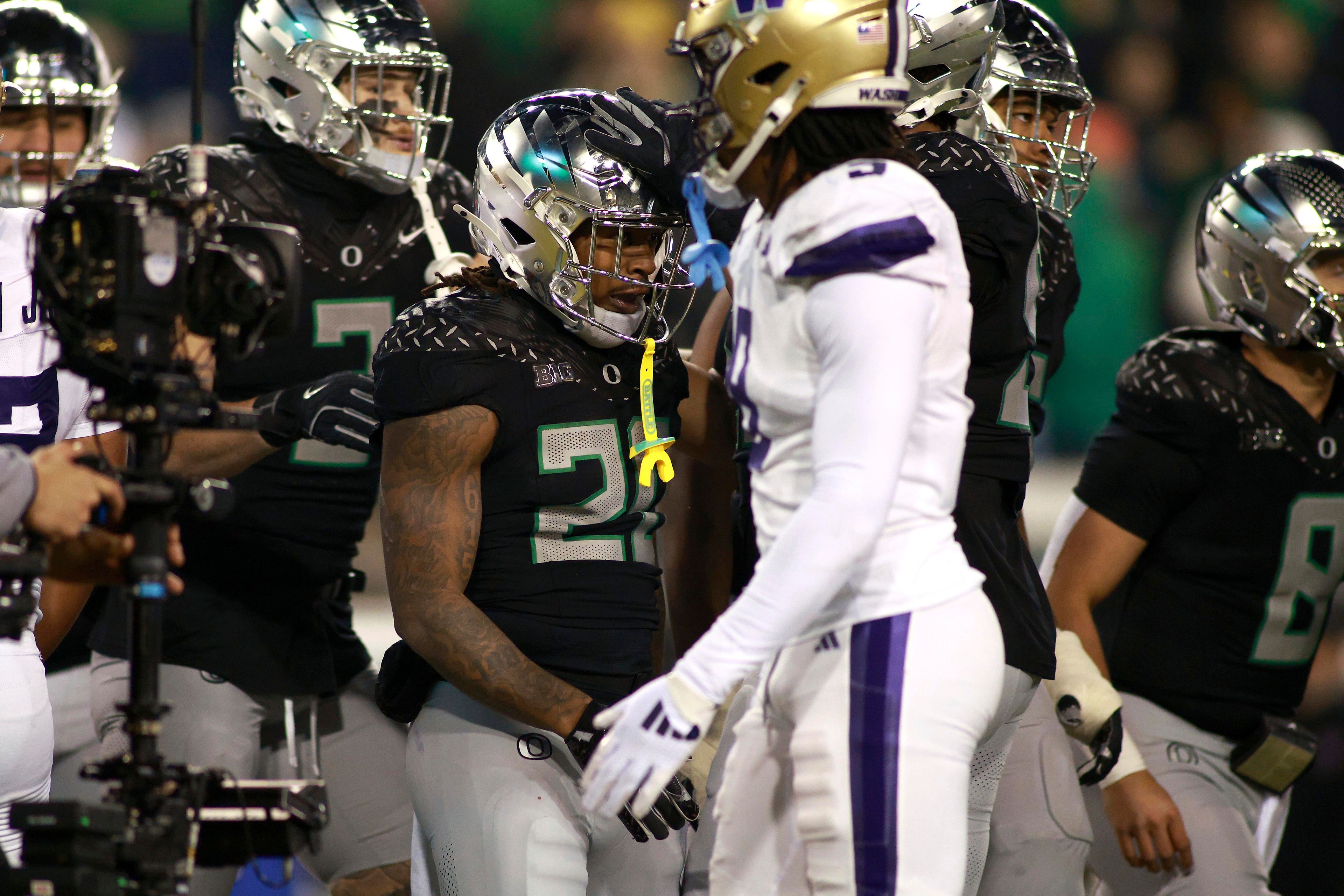 Oregon running back Jordan James is congratulated on a score during an NCAA college football game against Washington, Saturday, Nov. 30, 2024, in Eugene, Ore. (AP Photo/Lydia Ely)