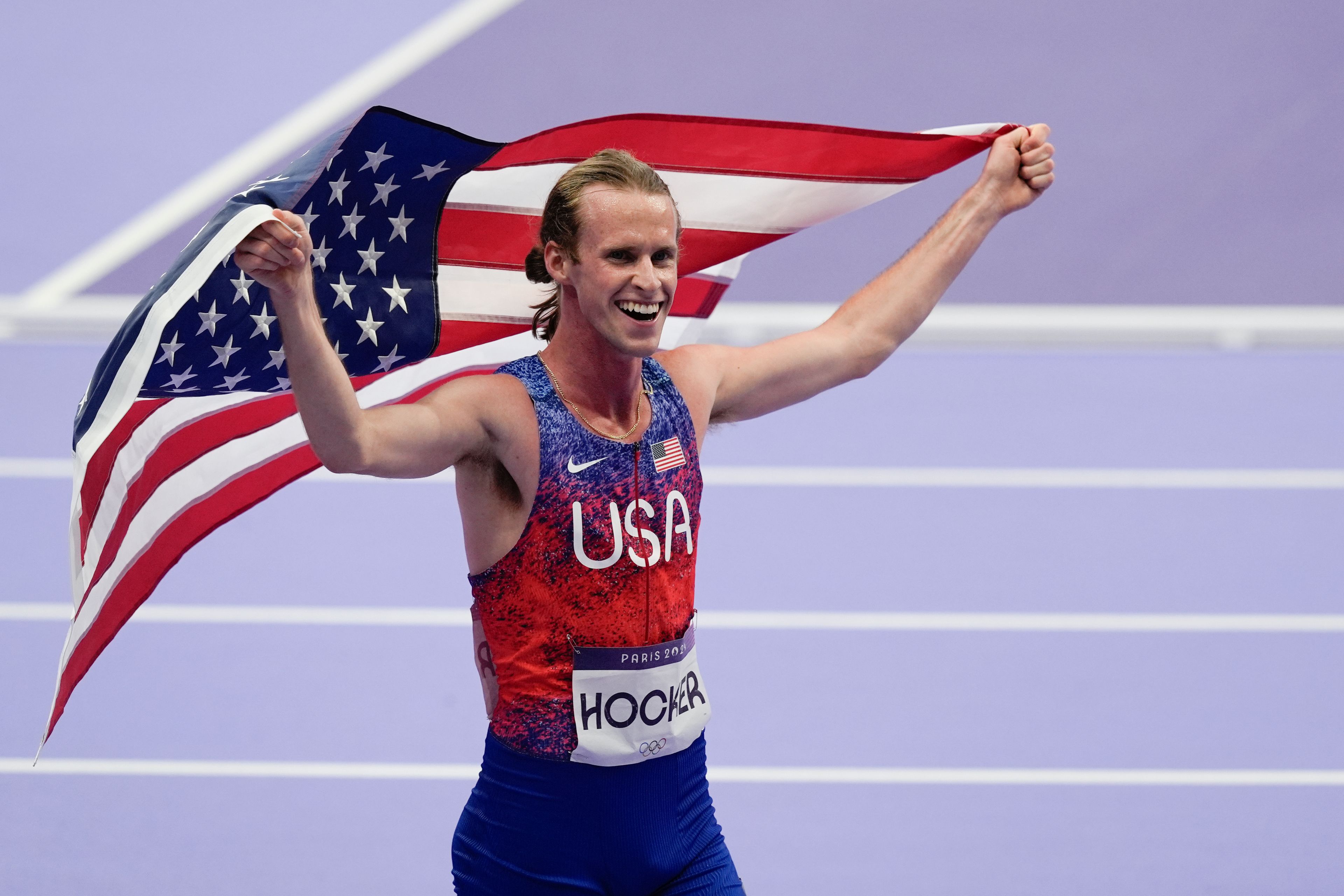 Cole Hocker, of the United States, celebrates winning gold in the men's 1500-meter final at the 2024 Summer Olympics, Tuesday, Aug. 6, 2024, in Saint-Denis, France. (AP Photo/Rebecca Blackwell)