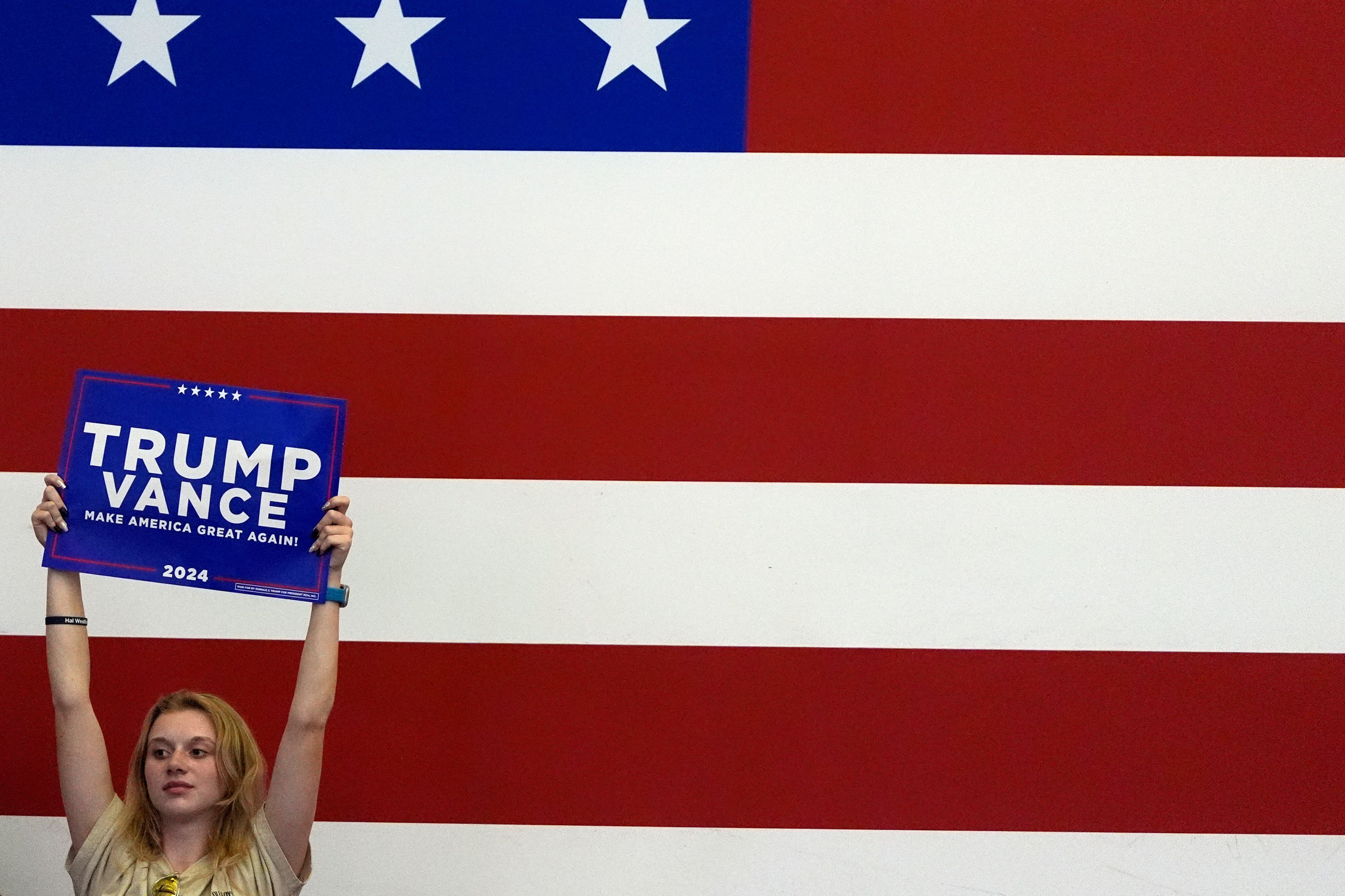 A supporter listens as Republican presidential nominee former President Donald Trump speaks at a campaign rally at Williams Arena at Mignes Coliseum, Monday, Oct. 21, 2024, in Greenville, N.C. (AP Photo/Julia Demaree Nikhinson)