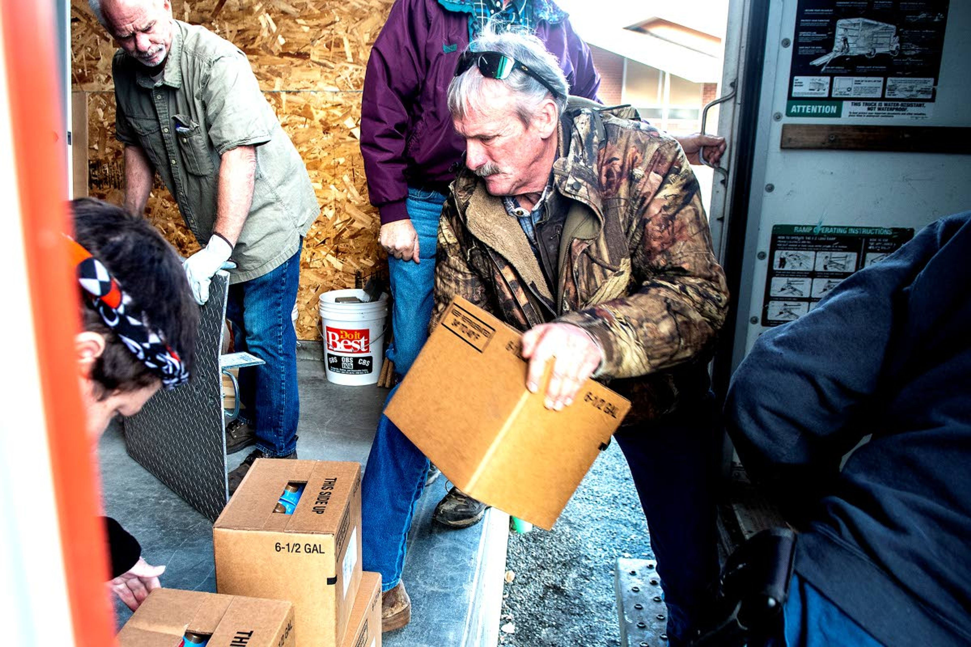 Jeff Goldman passes boxes of food from the truck to the new Camas Prairie Food Bank building in Grangeville.