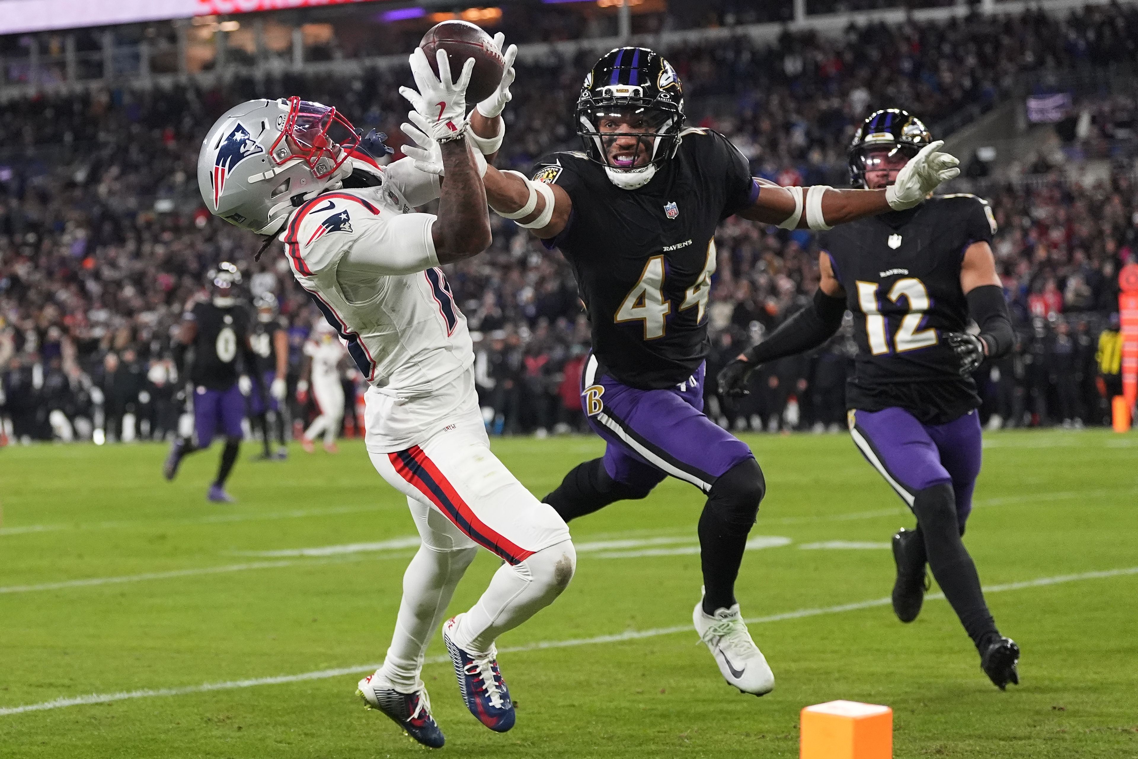 New England Patriots wide receiver Kyle Williams, left, catches a touchdown against Baltimore Ravens cornerback Marlon Humphrey (44) during the second half of an NFL football game, Sunday, Dec. 21, 2025, in Baltimore. (AP Photo/Stephanie Scarbrough)