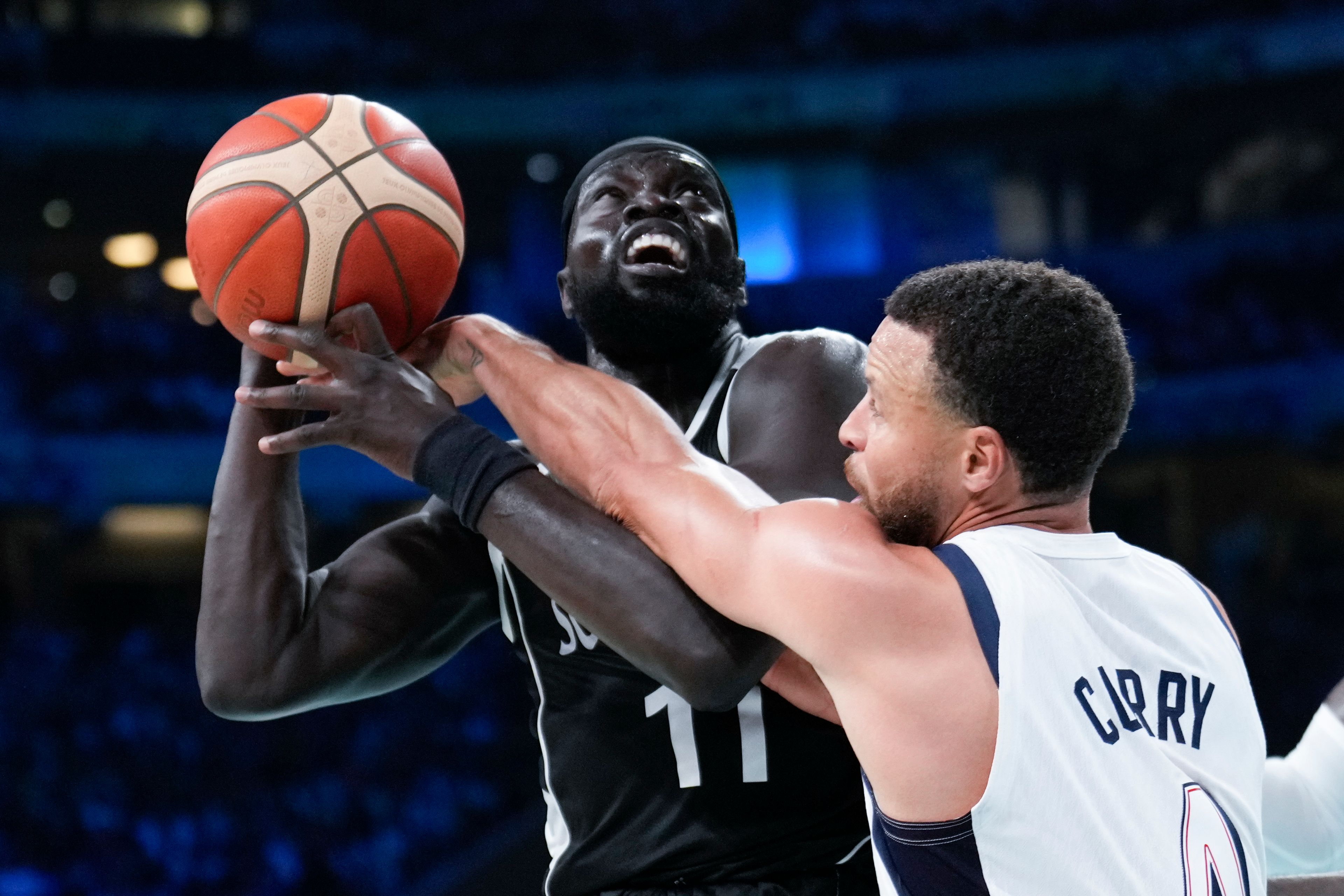 Stephen Curry, of the United States, fools Marial Shayok, of South Sudan, in a men's basketball game at the 2024 Summer Olympics, Wednesday, July 31, 2024, in Villeneuve-d'Ascq, France. (AP Photo/Mark J. Terrill)