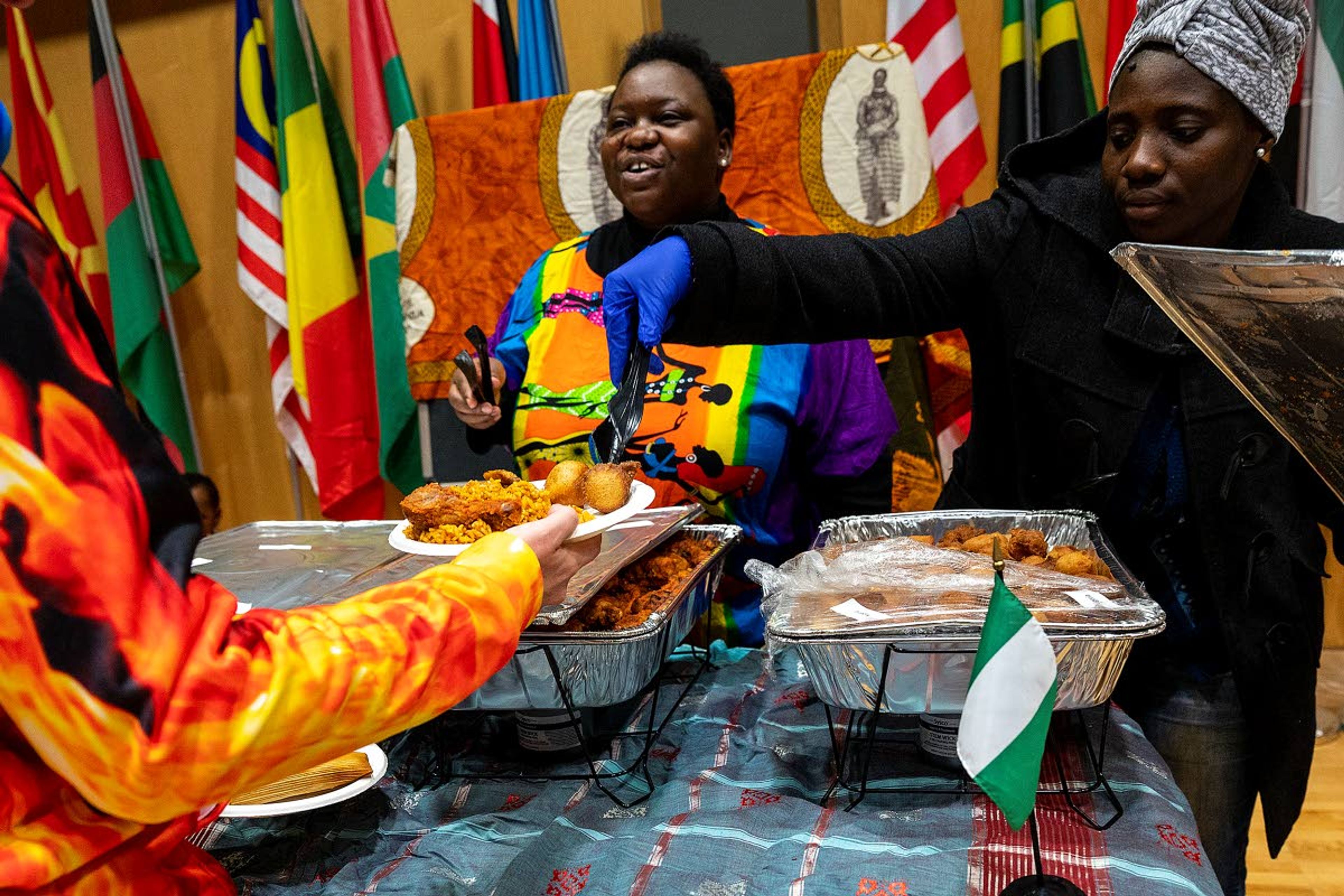 Members of the Nigerian exhibit serve up plates of dumplings, chicken and rice at the University of Idaho’s Cruise the World 2020 at the Pitman Center in Moscow on Saturday.