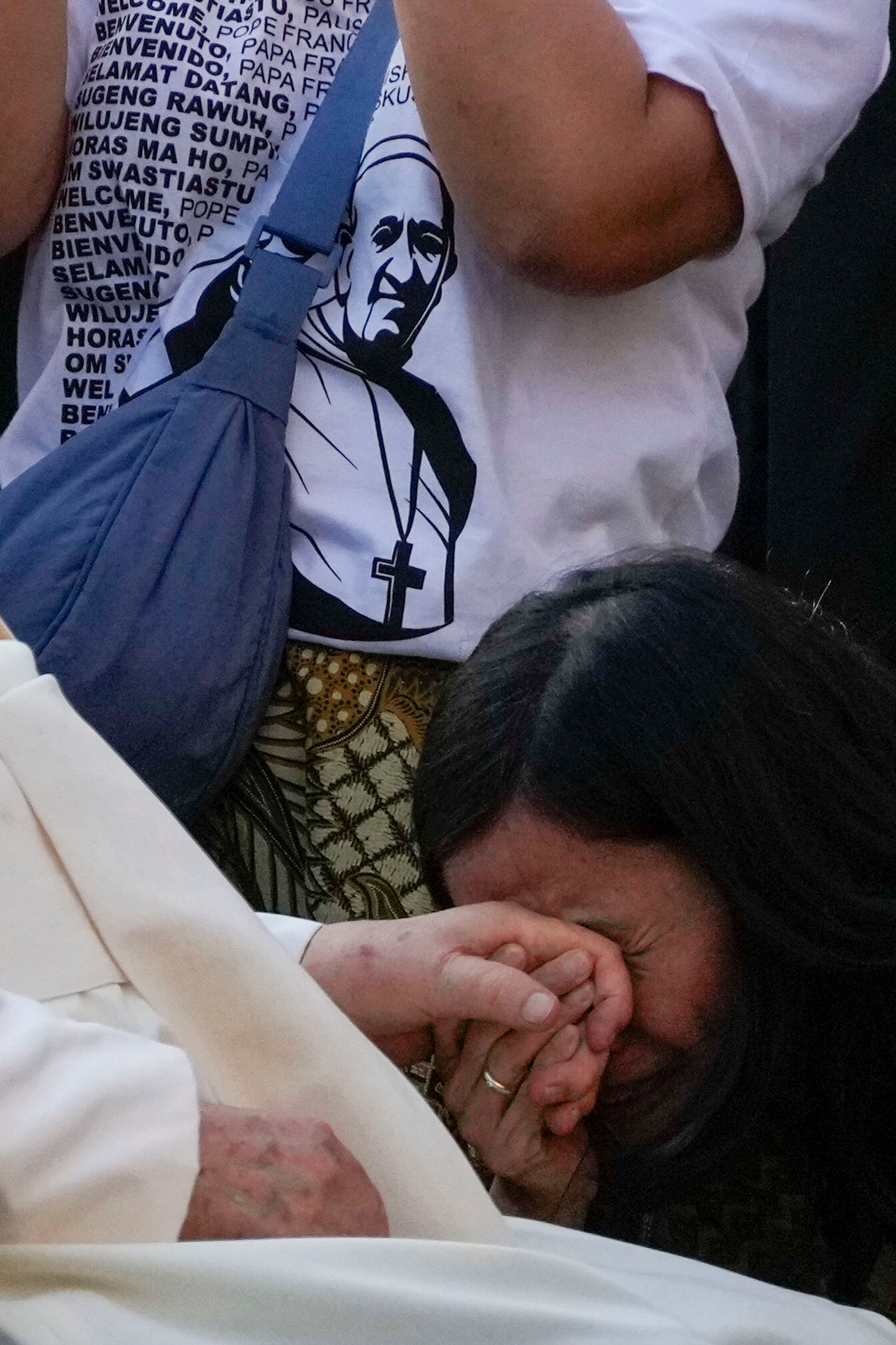 Pope Francis is greeted by faithful as he arrives at the Cathedral of Our Lady of the Assumption in Jakarta, Wednesday, Sept. 4, 2024. Pope Francis urged Indonesia to live up to its promise of "harmony in diversity" and fight religious intolerance on Wednesday, as he set a rigorous pace for an 11-day, four-nation trip through tropical Southeast Asia and Oceania that will test his stamina and health.