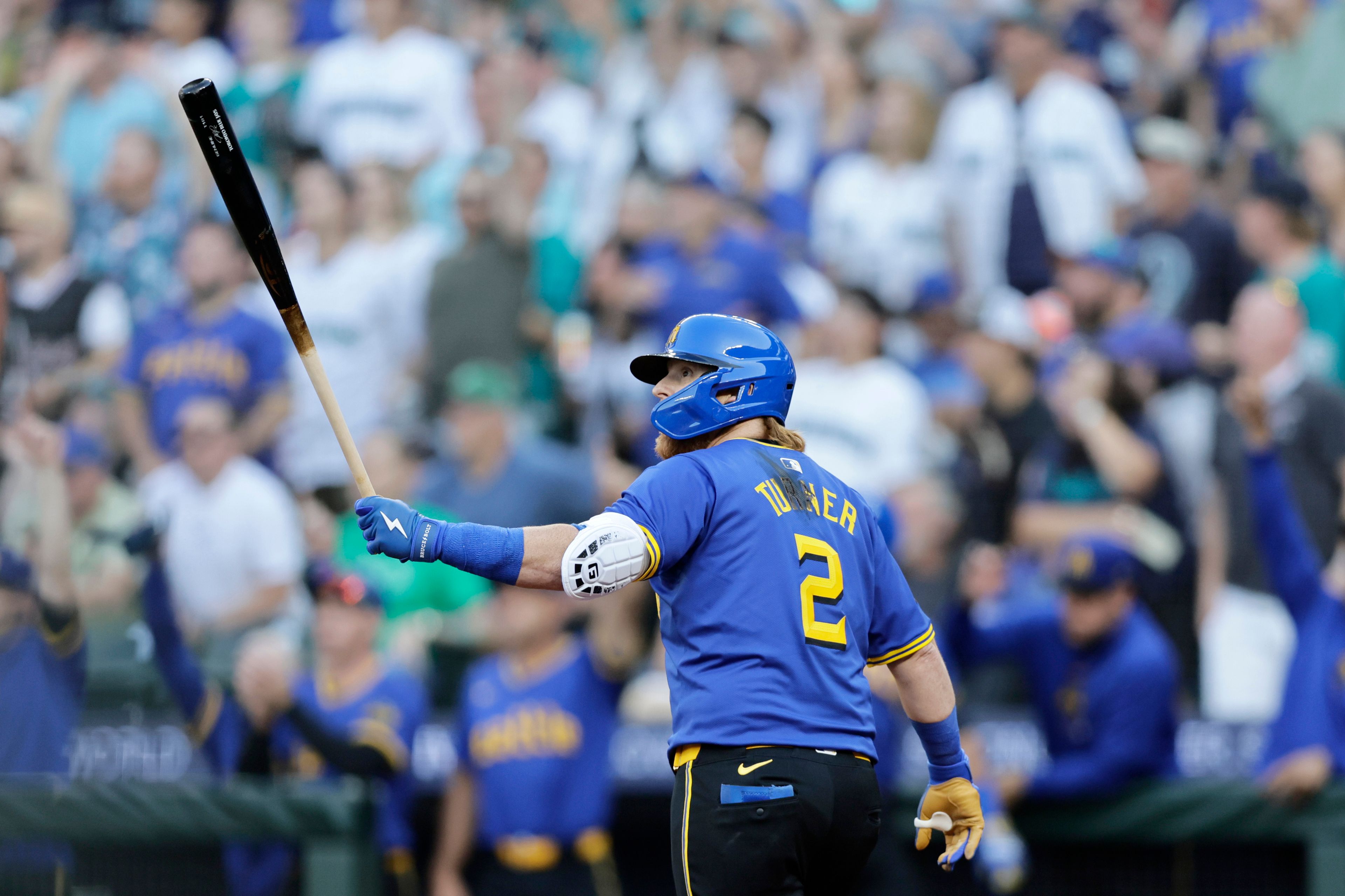 Seattle Mariners' Justin Turner watches the flight of his grand slam off Philadelphia Phillies starting pitcher Tyler Phillips during the second inning in a baseball game, Friday, Aug. 2, 2024, in Seattle. (AP Photo/John Froschauer)