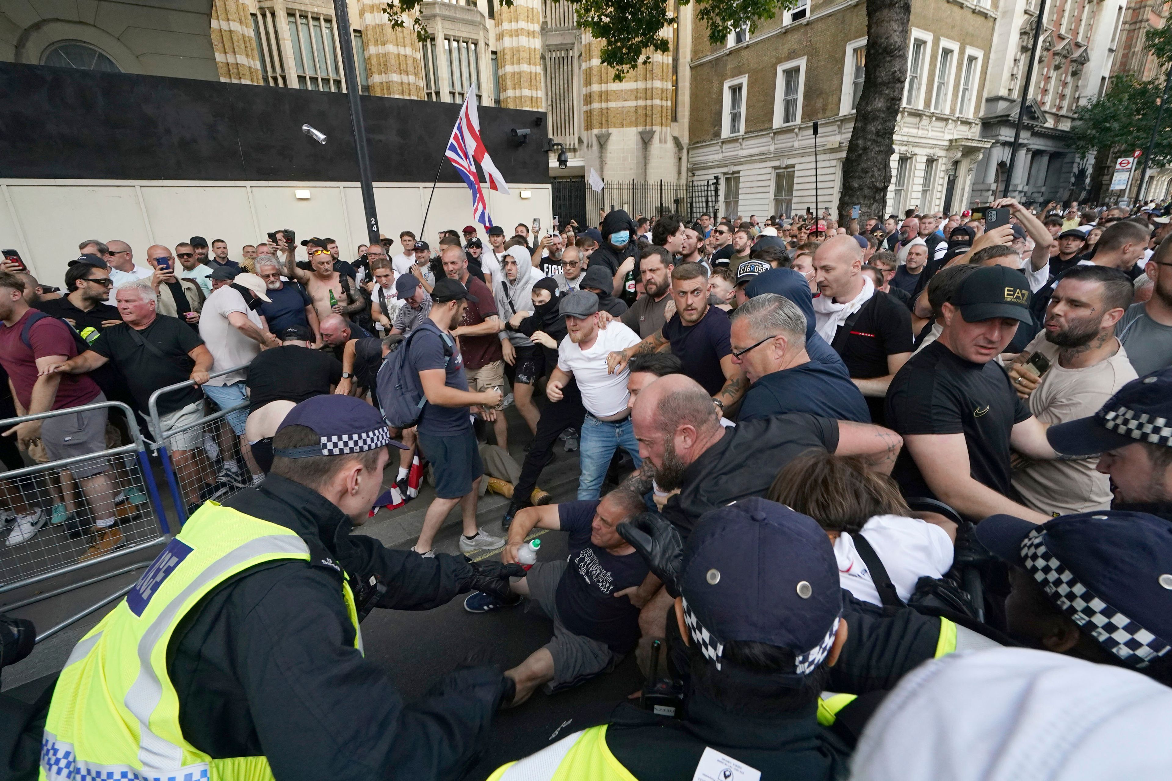 Police officers clash with protesters during a 'Enough is Enough' protest rally in Whitehall, London, Wednesday July 31, 2024 following the fatal stabbing of three children at a Taylor Swift-themed holiday club on Monday in Southport. (Jordan Pettitt/PA via AP)