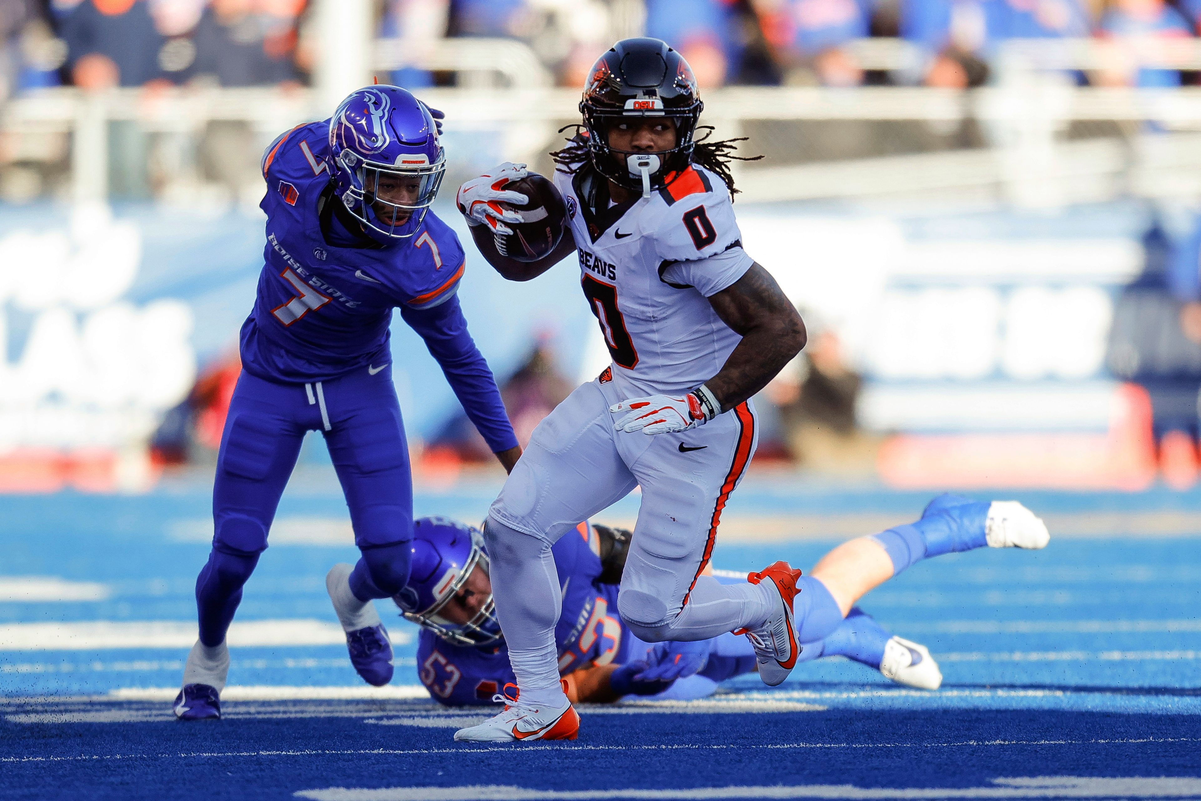 Oregon State running back Anthony Hankerson (0) turns up field on a run in front of Boise State cornerback A'Marion McCoy (7) in the first half of an NCAA college football game, Friday, Nov. 29, 2024, in Boise, Idaho. (AP Photo/Steve Conner)