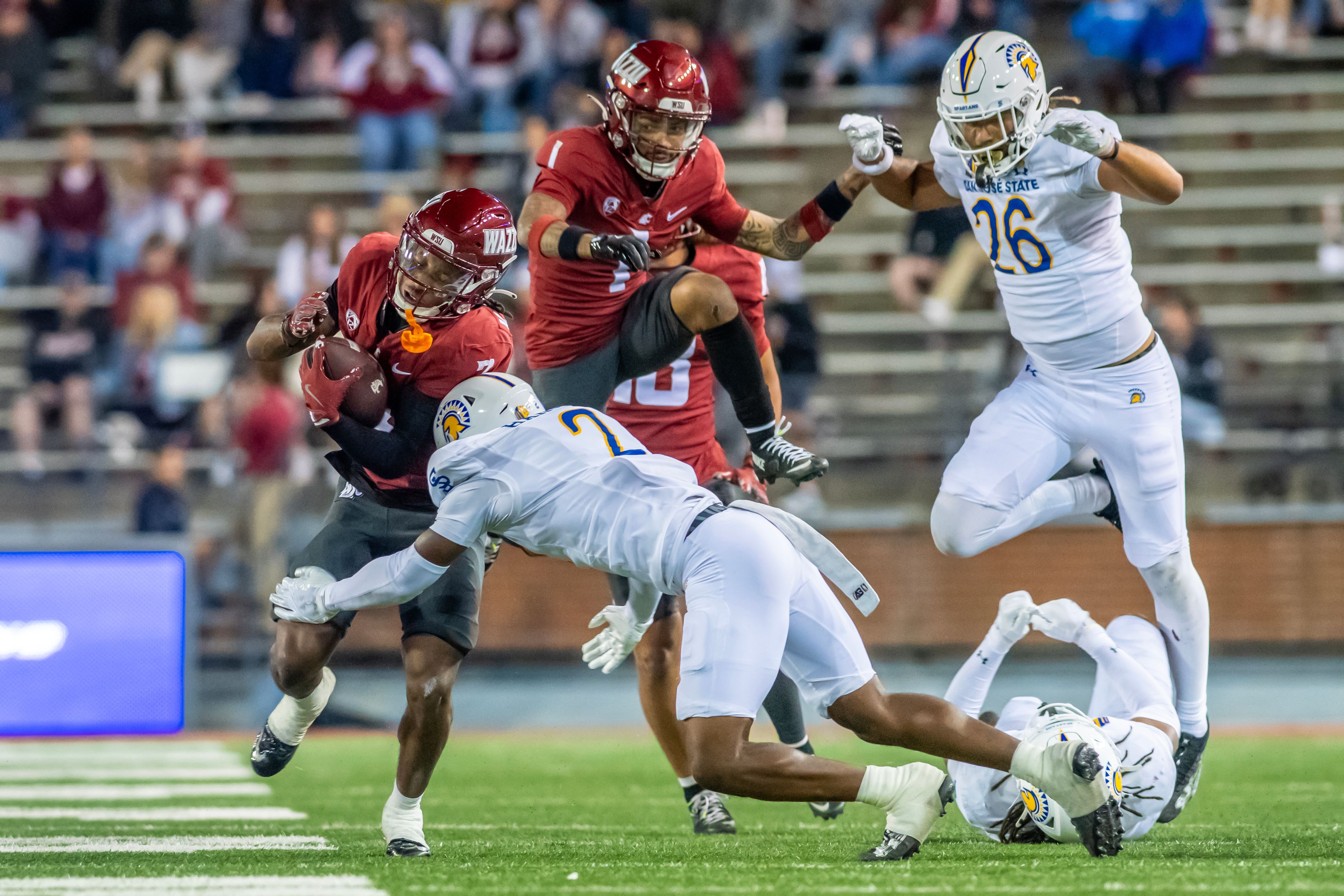 Washington State wide receiver Kyle Williams  is tackled by San Jose State defensive back DJ Harvey during a quarter of a game Friday at Gesa Field in Pullman.,