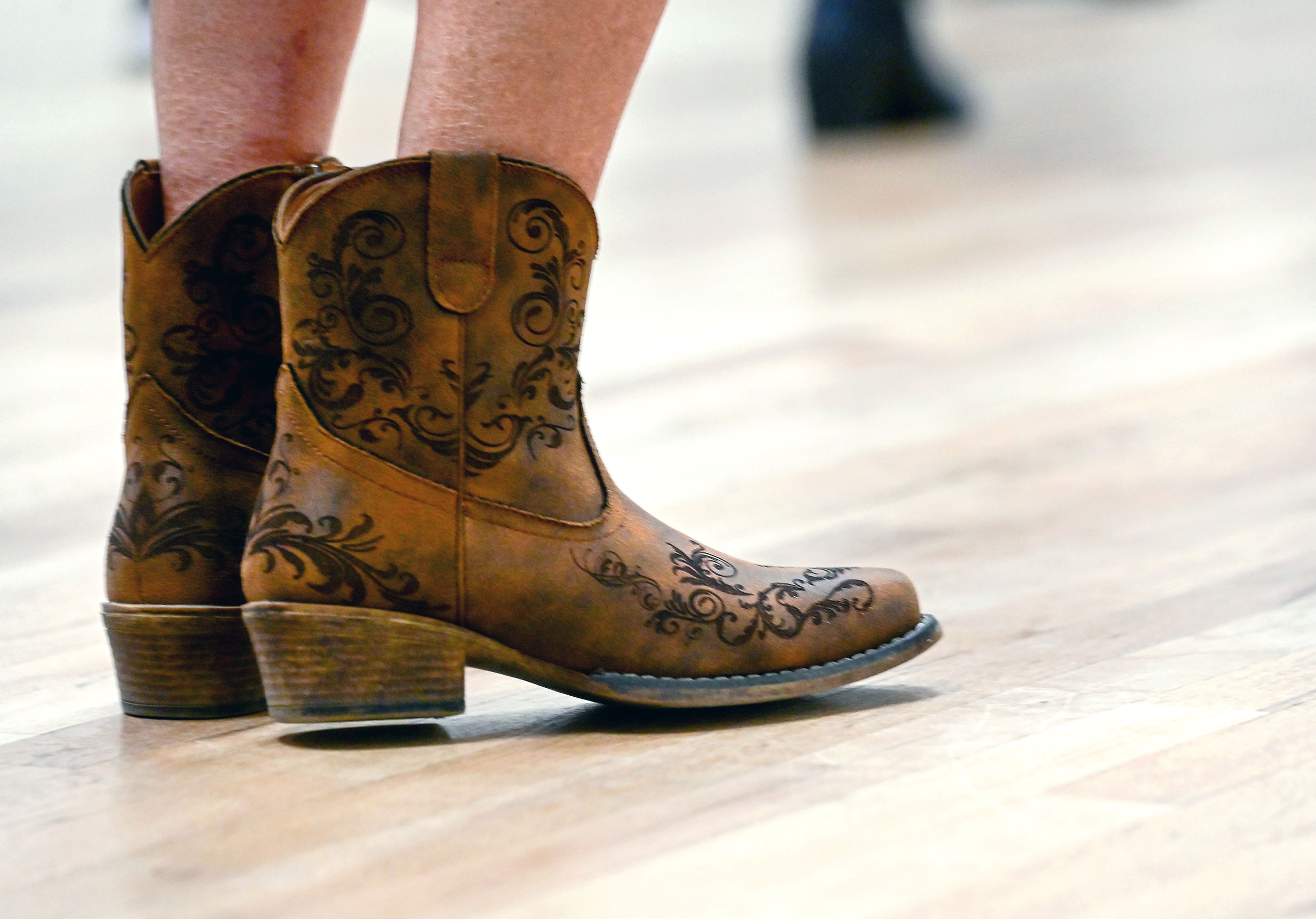 Camille Holley sports boots for line dancing at the Sixth Street Senior Center on Wednesday in Clarkston.