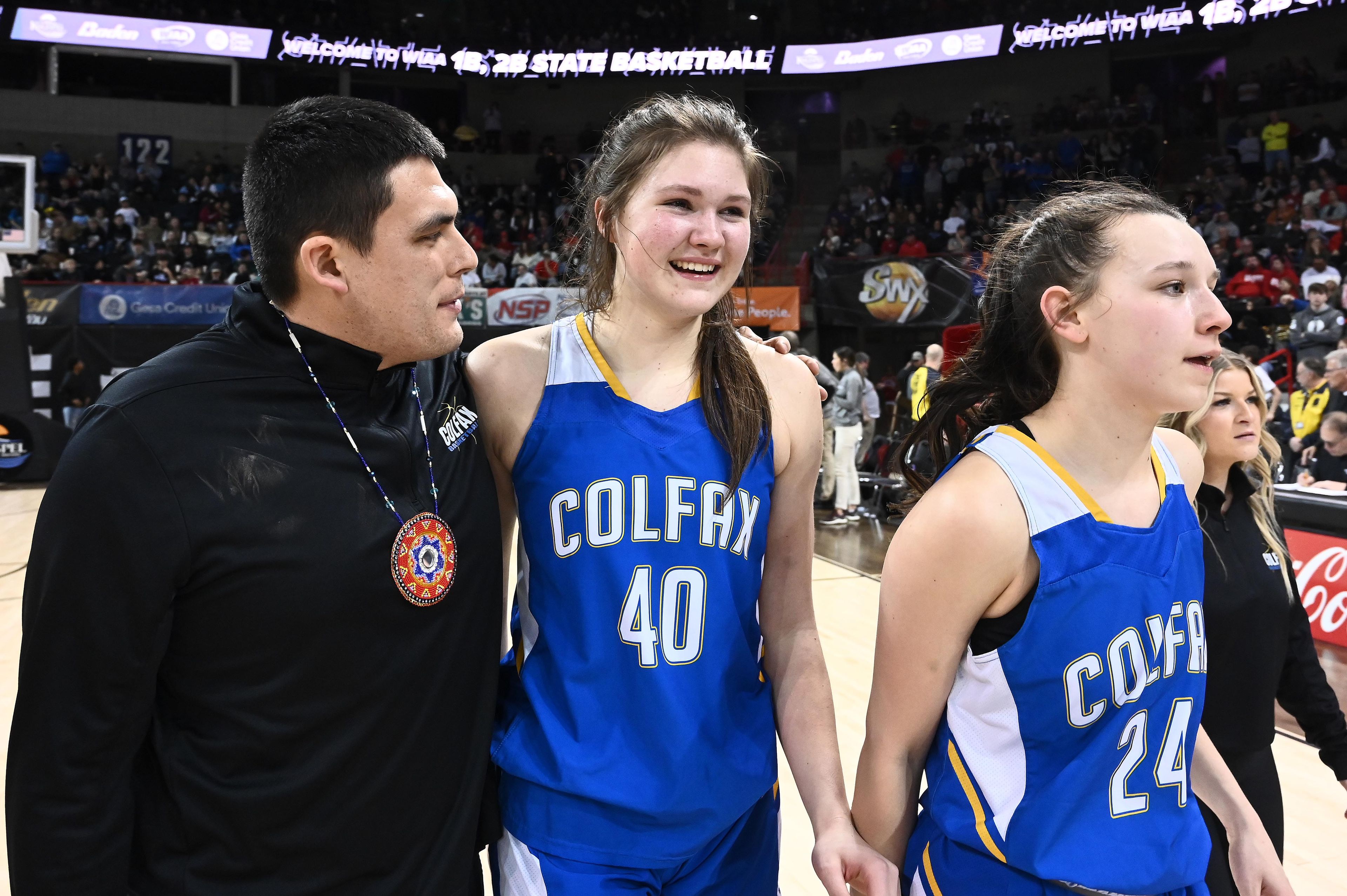 Colfax Bulldogs Brynn McGaughy, center, celebrate after beating the Okanogan Bulldogs 55-50 in Washington Class 2B girls basketball state championship game March. 4, 2023 at the Spokane Arena in Spokane.