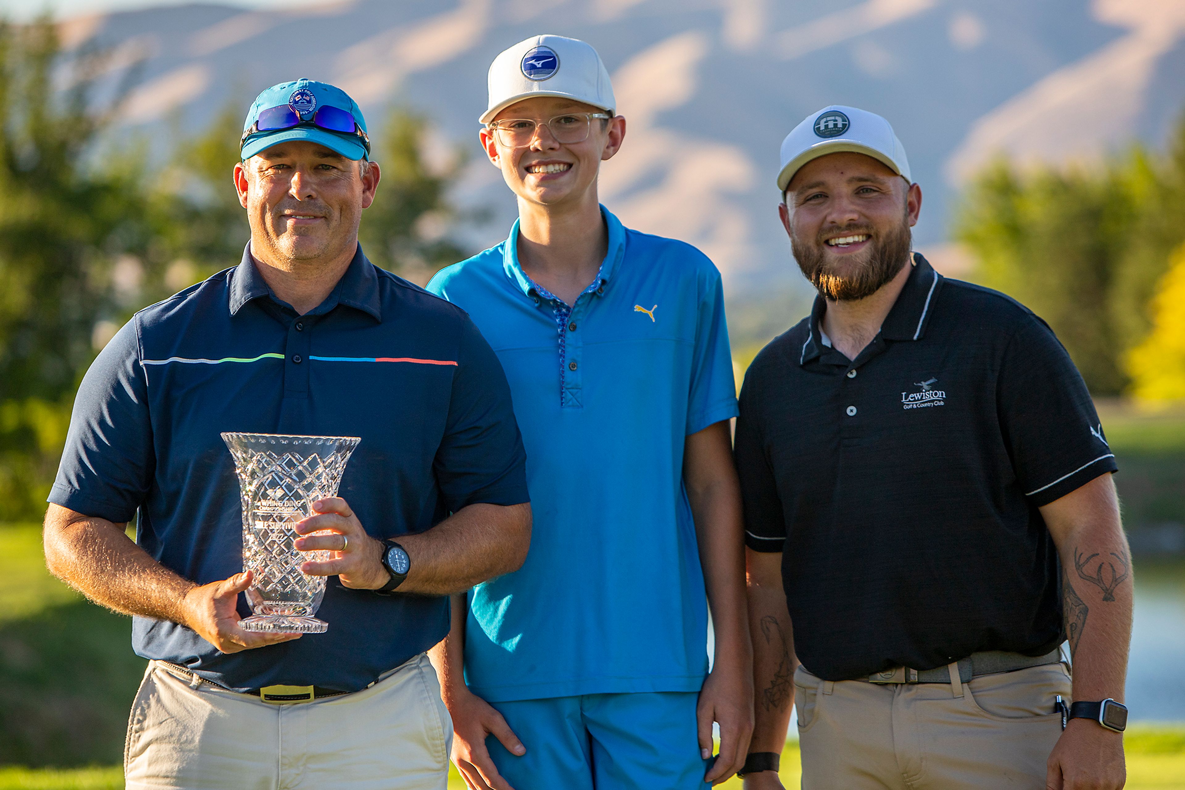 Jason Huff, left, of Moscow, poses with his trophy after taking first place in the 2022 Sole Survivor golf tournament Monday at the Lewiston Golf and Country Club.