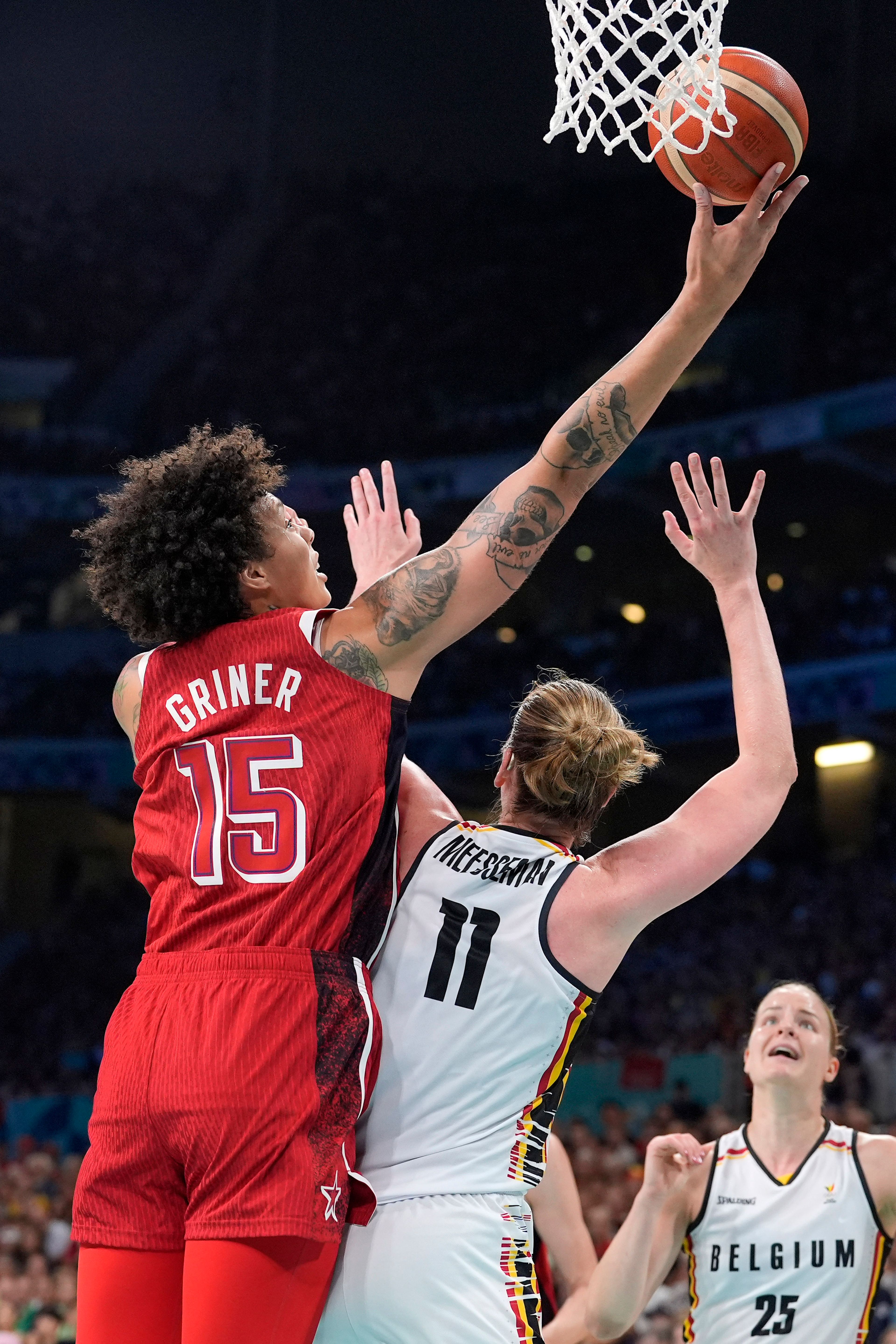 United States' Brittney Griner, left, shoots as Belgium's Emma Meesseman defends during a women's basketball game at the 2024 Summer Olympics, Thursday, Aug. 1, 2024, in Villeneuve-d'Ascq, France. (AP Photo/Michael Conroy)