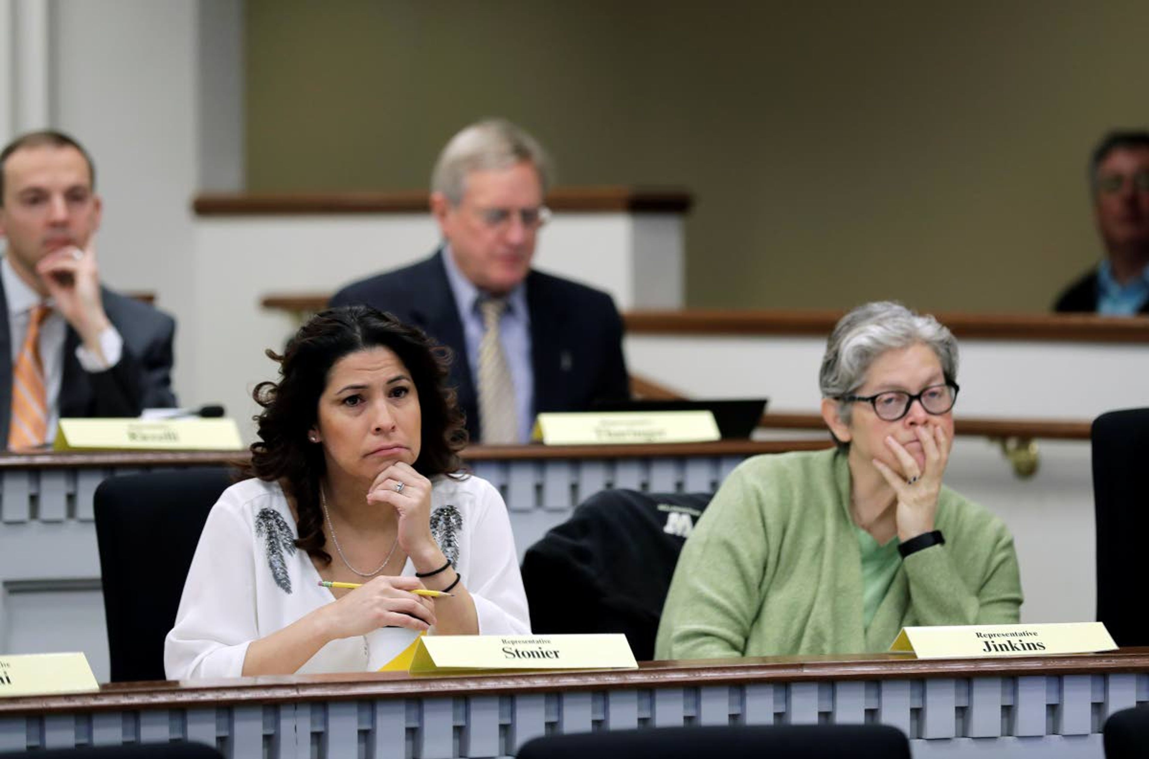 Rep. Monica Stonier, D-Vancouver, lower left, and Rep. Laurie Jenkins, D-Tacoma, right, listen Friday, Feb. 8, 2019, during a public hearing before the House Health Care & Wellness Committee at the Capitol in Olympia, Wash. Amid a measles outbreak that has sickened people in Washington state and Oregon, lawmakers heard public testimony Friday on a bill that would remove parents' ability to claim a philosophical exemption to opt their school-age children out of the combined measles, mumps and rubella vaccine. (AP Photo/Ted S. Warren)