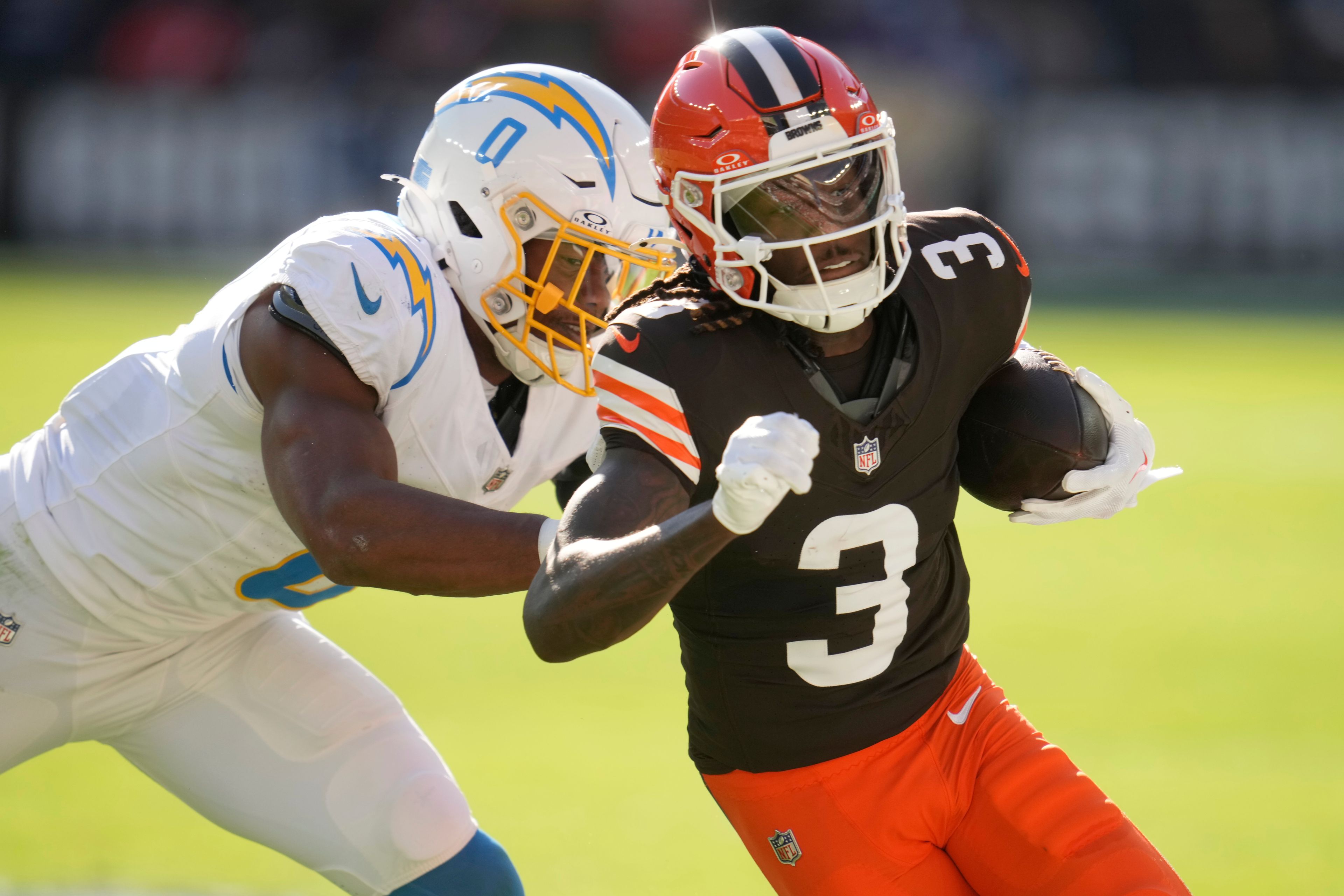 Cleveland Browns wide receiver Jerry Jeudy (3) is hit by Los Angeles Chargers linebacker Daiyan Henley (0) in the first half of an NFL football game Sunday, Nov. 3, 2024, in Cleveland. (AP Photo/Sue Ogrocki)