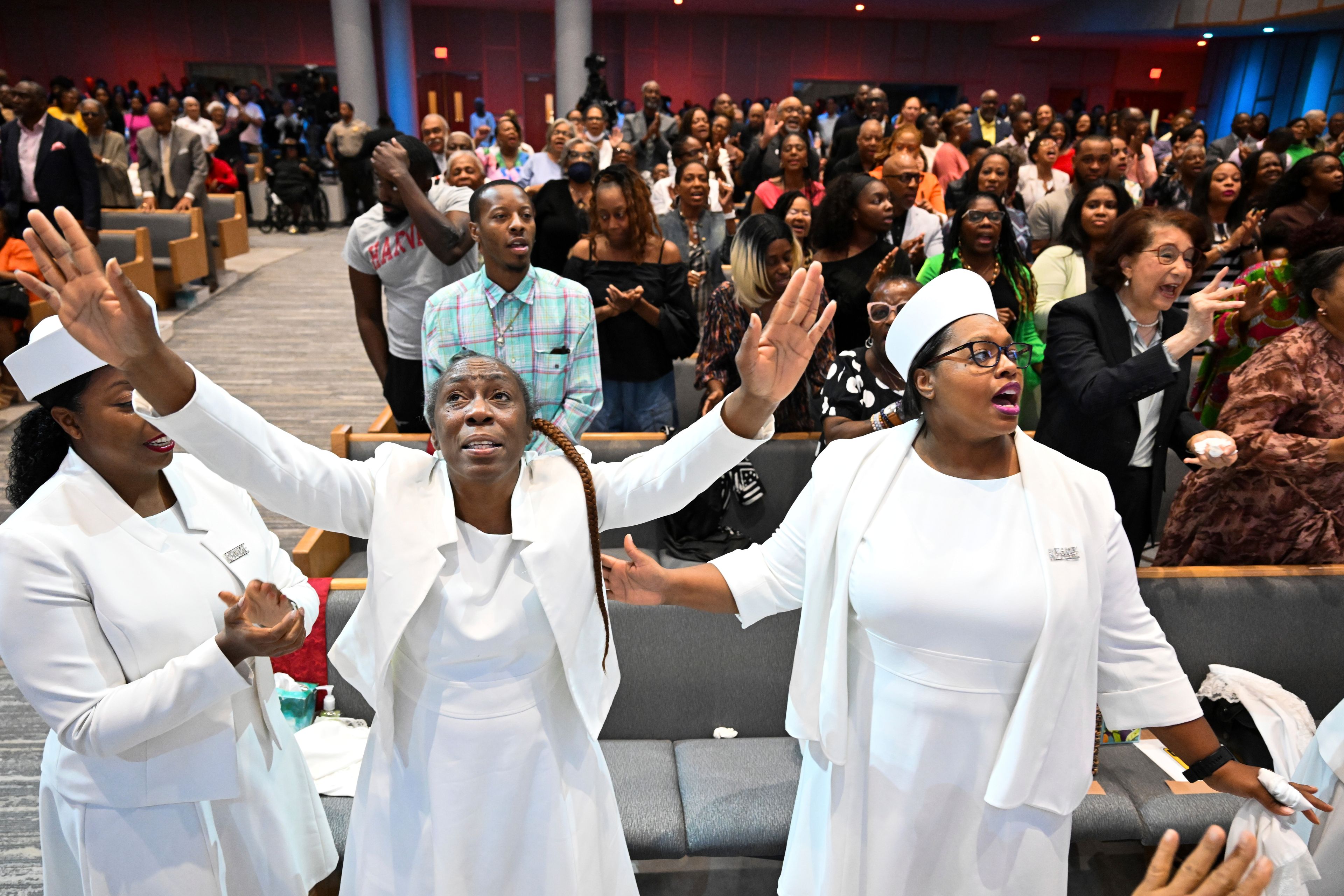 Members of the congregation at Kingdom Fellowship AME Church raise her hands in praise during church service, Sunday, June 2, 2024, in Calverton, Md. The suburban Maryland congregation, led by the Rev. Matthew L. Watley, has landed at the top of a list of the fastest-growing churches in America.