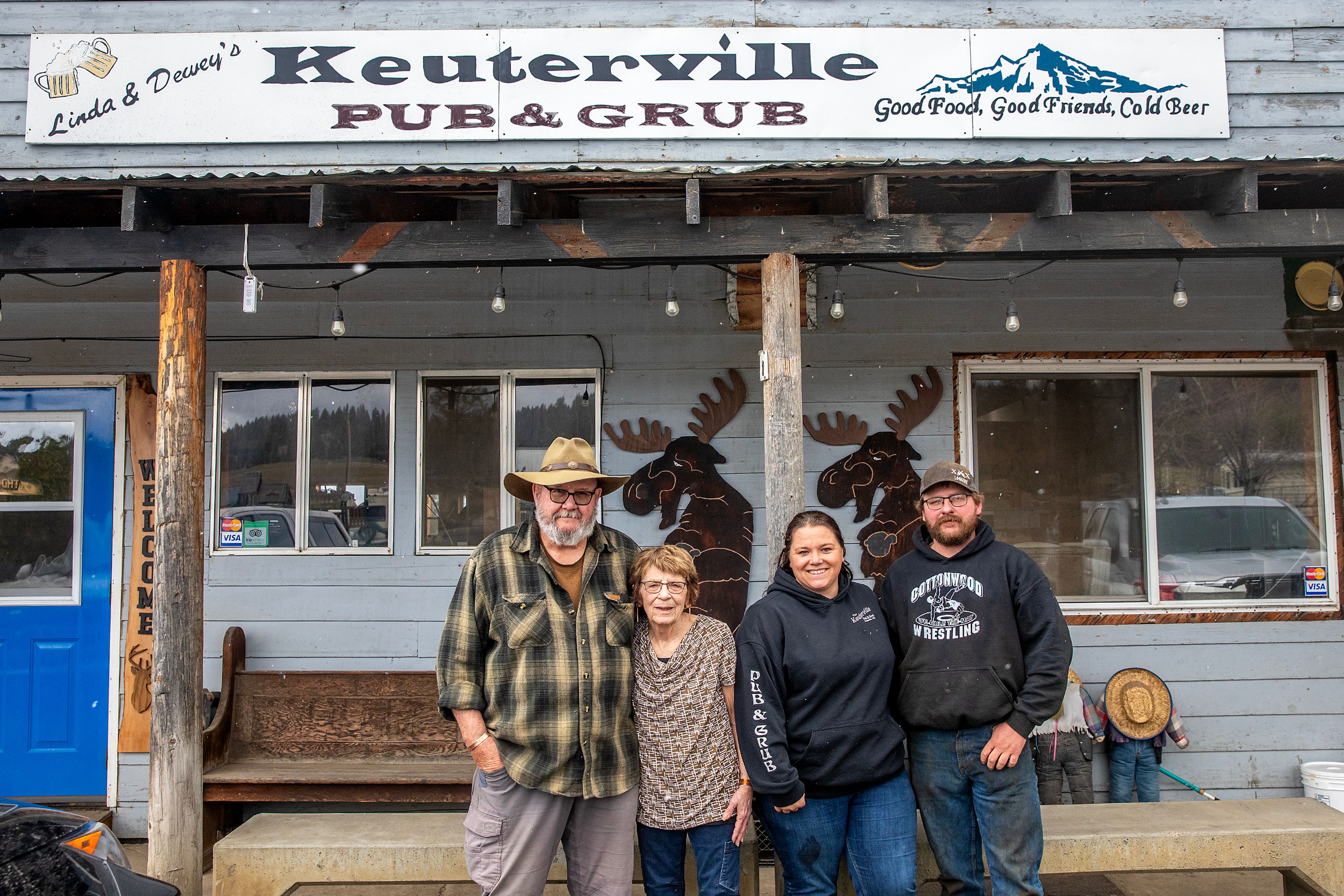 Old owners Linda and Dewey Elliot, left, stand with the new owners Brandee and Jeremy Ross Thursday at the Keuterville Pub & Grub.