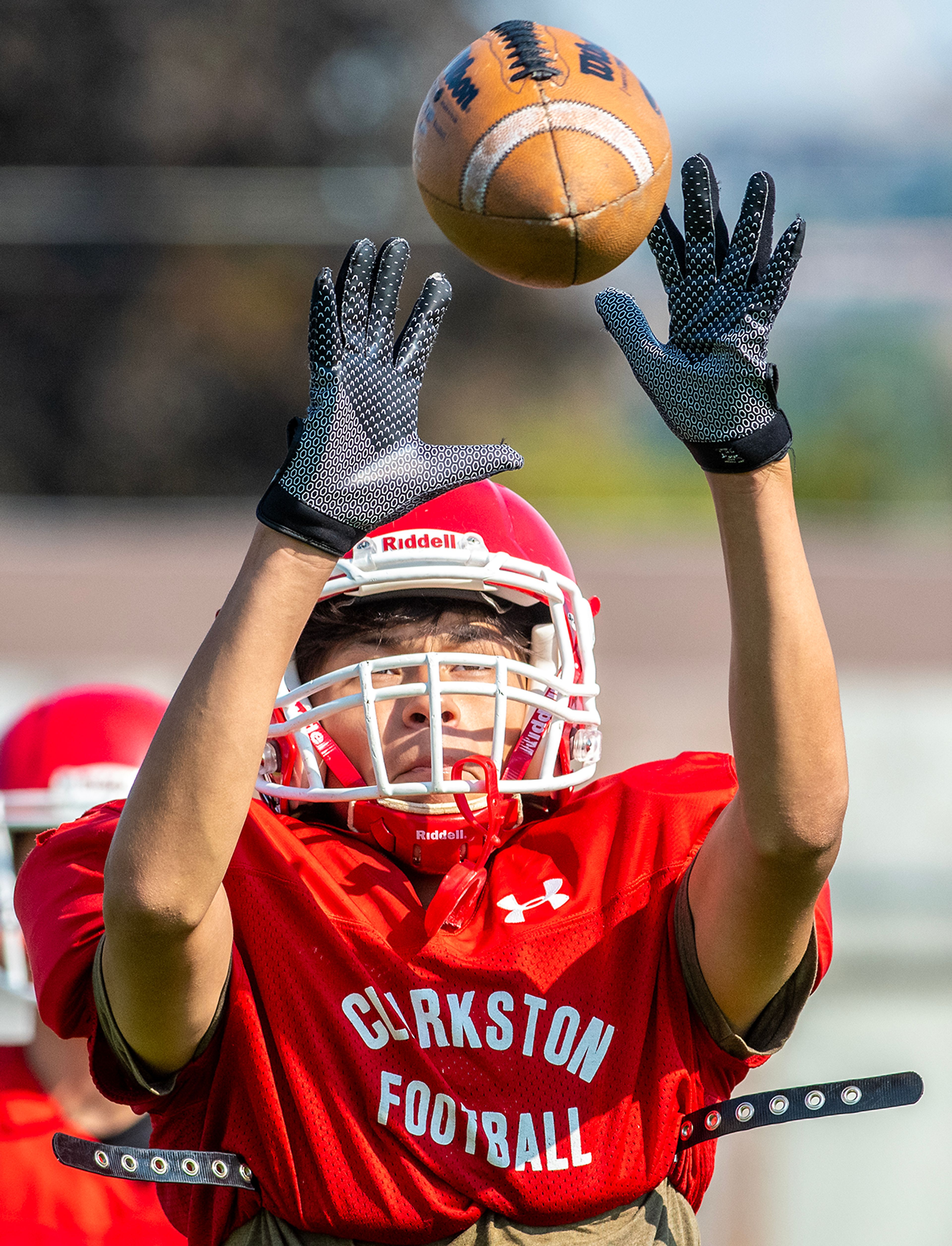 Keinai Picard makes a catch at football practice Tuesday in Clarkston.