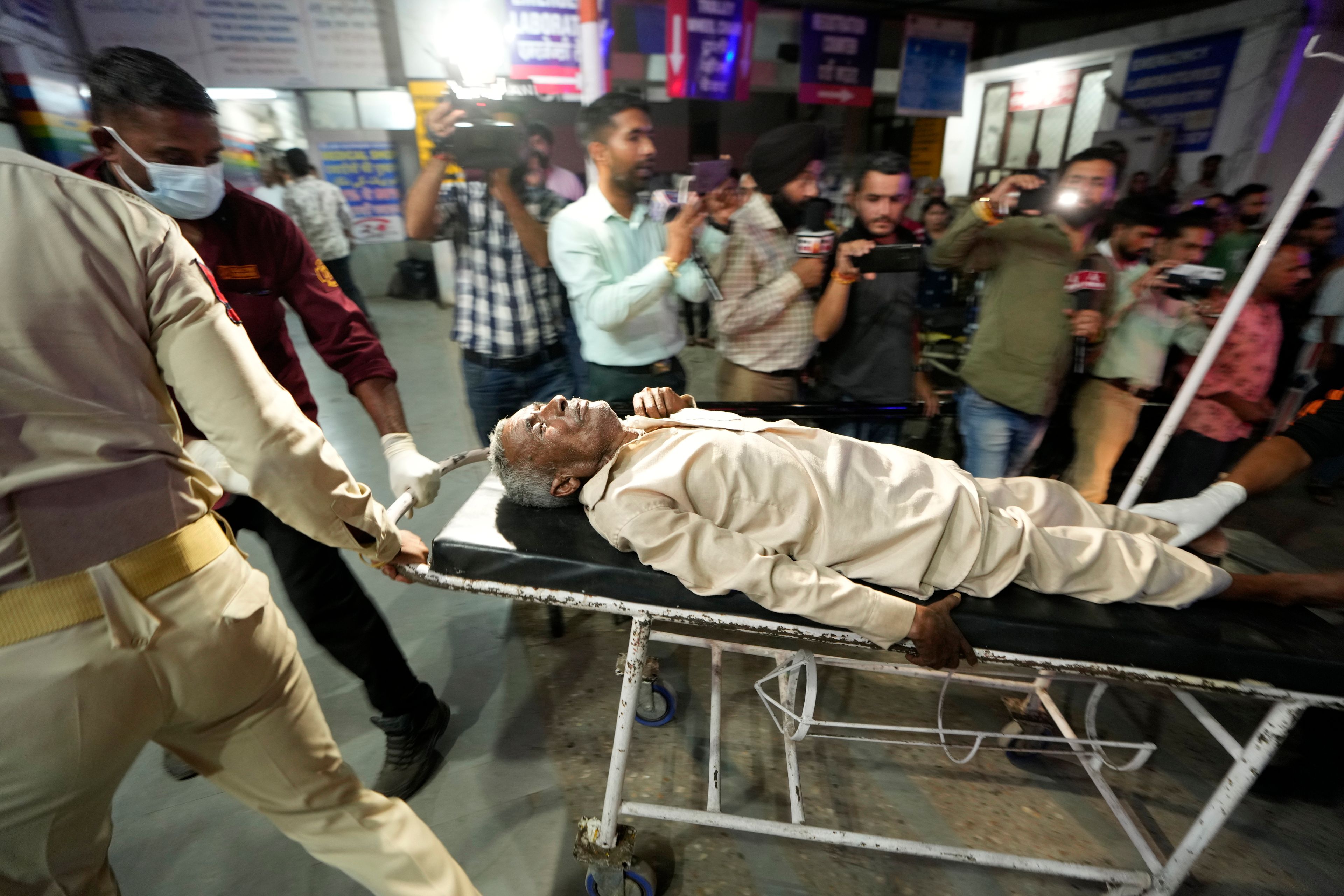 An injured man is brought to the Government Medical College Hospital in Jammu after the bus he was traveling in fell into a deep gorge in the Pouni area of Jammu's Reasi district, India, Sunday, June 9, 2024. Officials in Indian-controlled Kashmir say at least nine people have been killed after suspected militants fired at a bus with Hindu pilgrims, which then fell into a deep gorge.